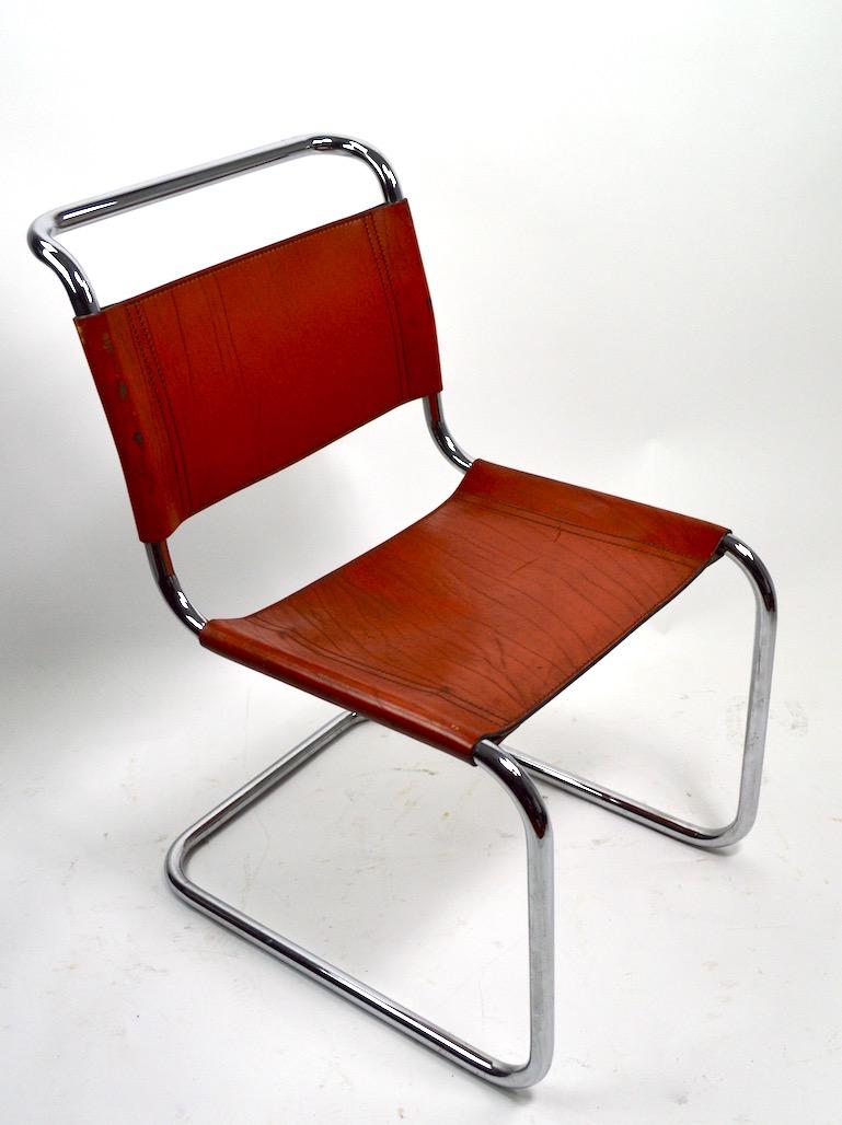 Wonderful patinated leather on bright tubular chrome frames, set of six matching dining chairs attributed to Knoll. These chairs are in very good original condition, showing expected nicks and scuffs to the leather (pictured ) normal and consistent