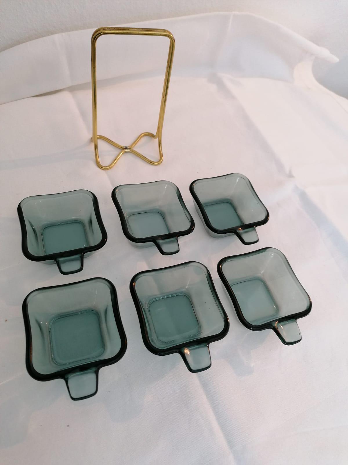 A set of six stackable ashtrays design in the 1950s by Wilhelm Wagenfeld for WMF (Würtenbergische Metallwaren Fabrik)
Brass frame green glass trays marked with WMF.