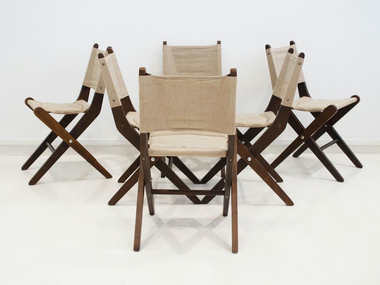 Six folding chairs of stained beech with canvas seat and backrest. Manufactured in Denmark by Sorø Møbelfabrik, model 330. Height when folded - 97 cm.