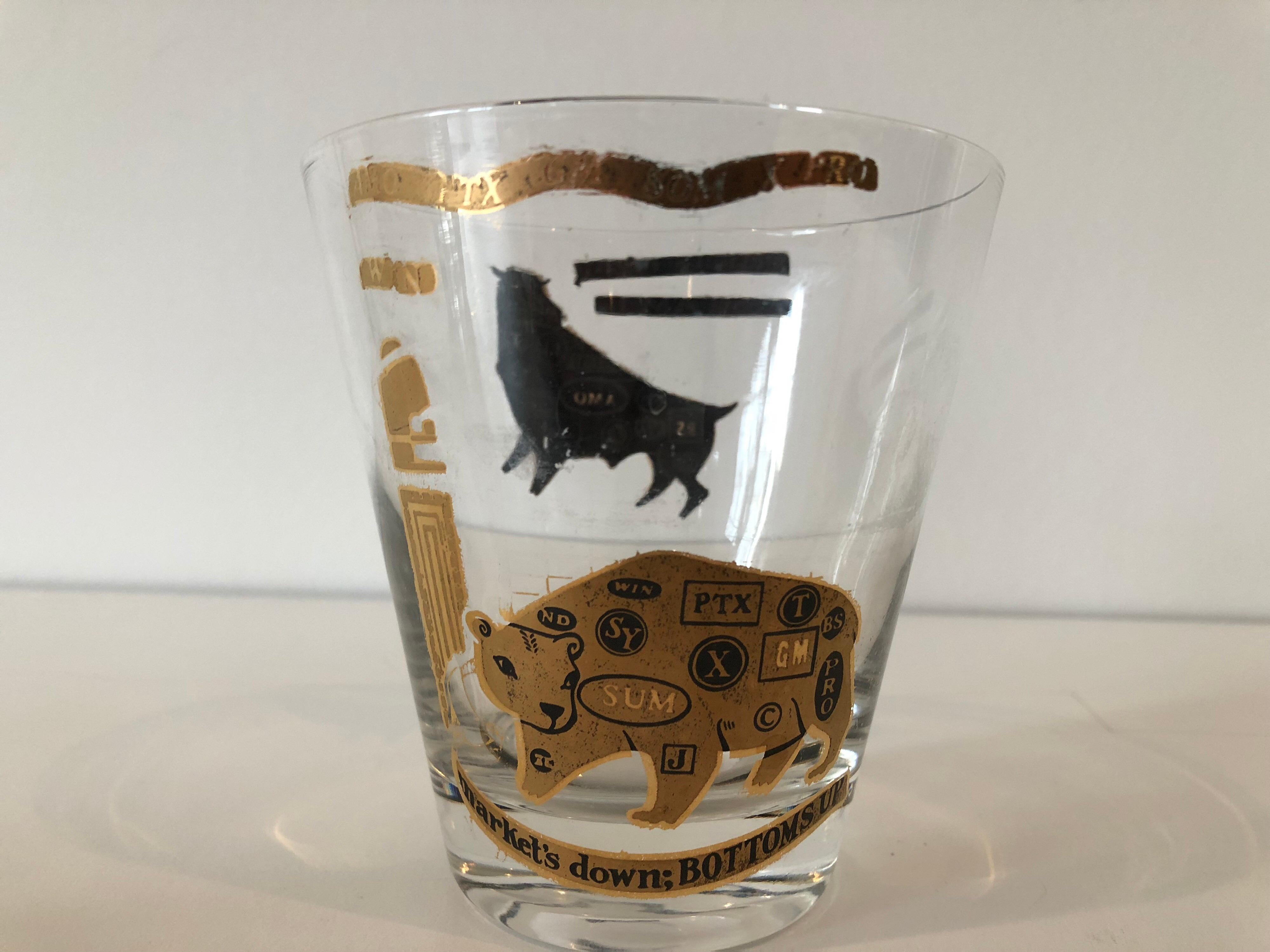 A vintage set of six stock market themed low ball glasses. Each with gold exterior and black interior bull and bear decorations- 