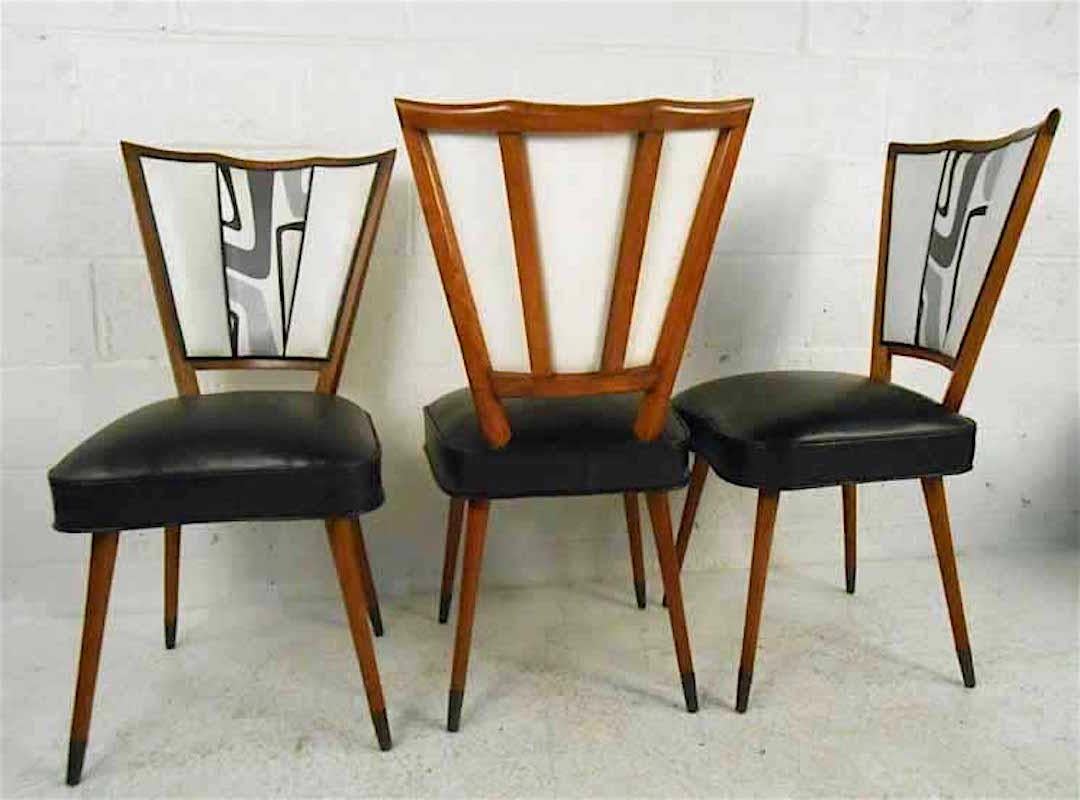 Very unique set of Italian dining chairs featuring scalloped backs and tapered legs. 
Please confirm item location (NY or NJ) with dealer.