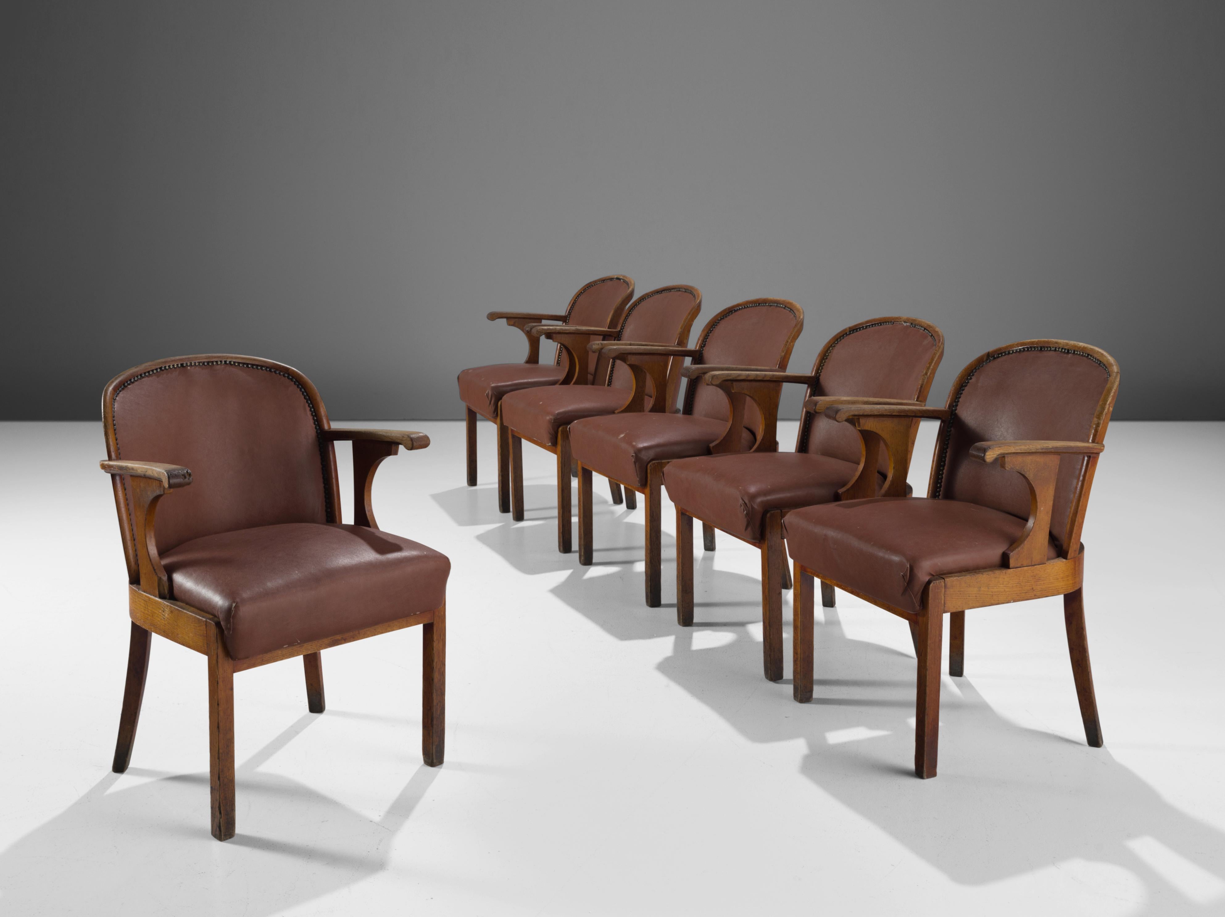 Set of six chairs, oak, brown faux leather, Sweden, 1940s

This set of six dining chairs with original leatherette upholstery is made by a Swedish cabinetmaker. The chairs have a solid oak frame with tapered legs. The central feature of this design