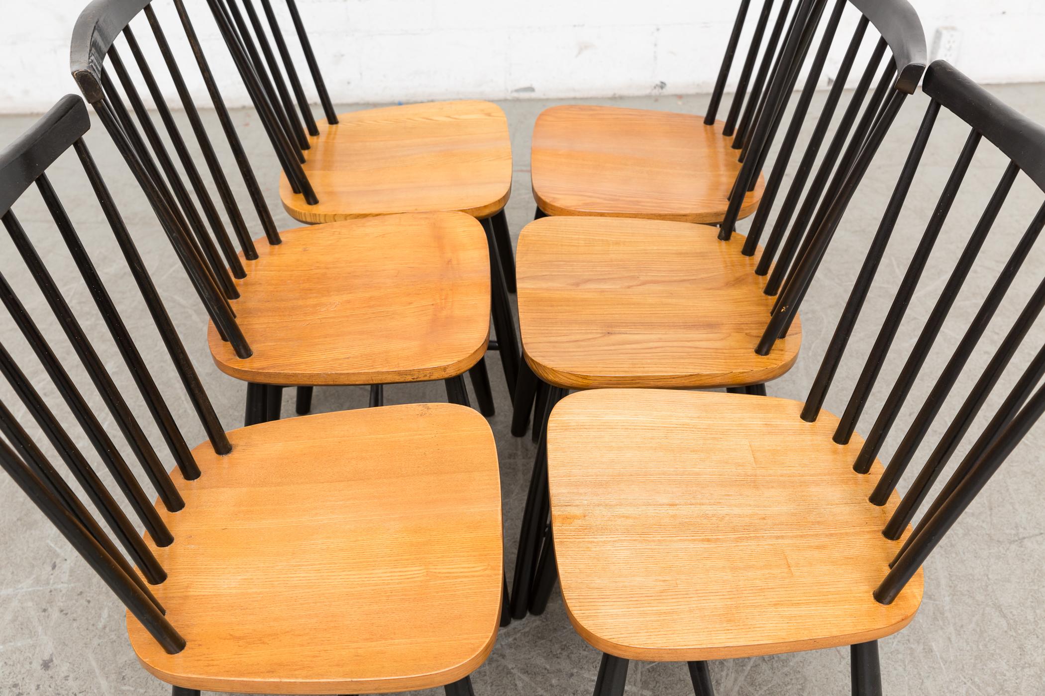 Set of six matching Tapiovaara style spindle back side chairs with black lacquered wood and lightly refinished teak seats.