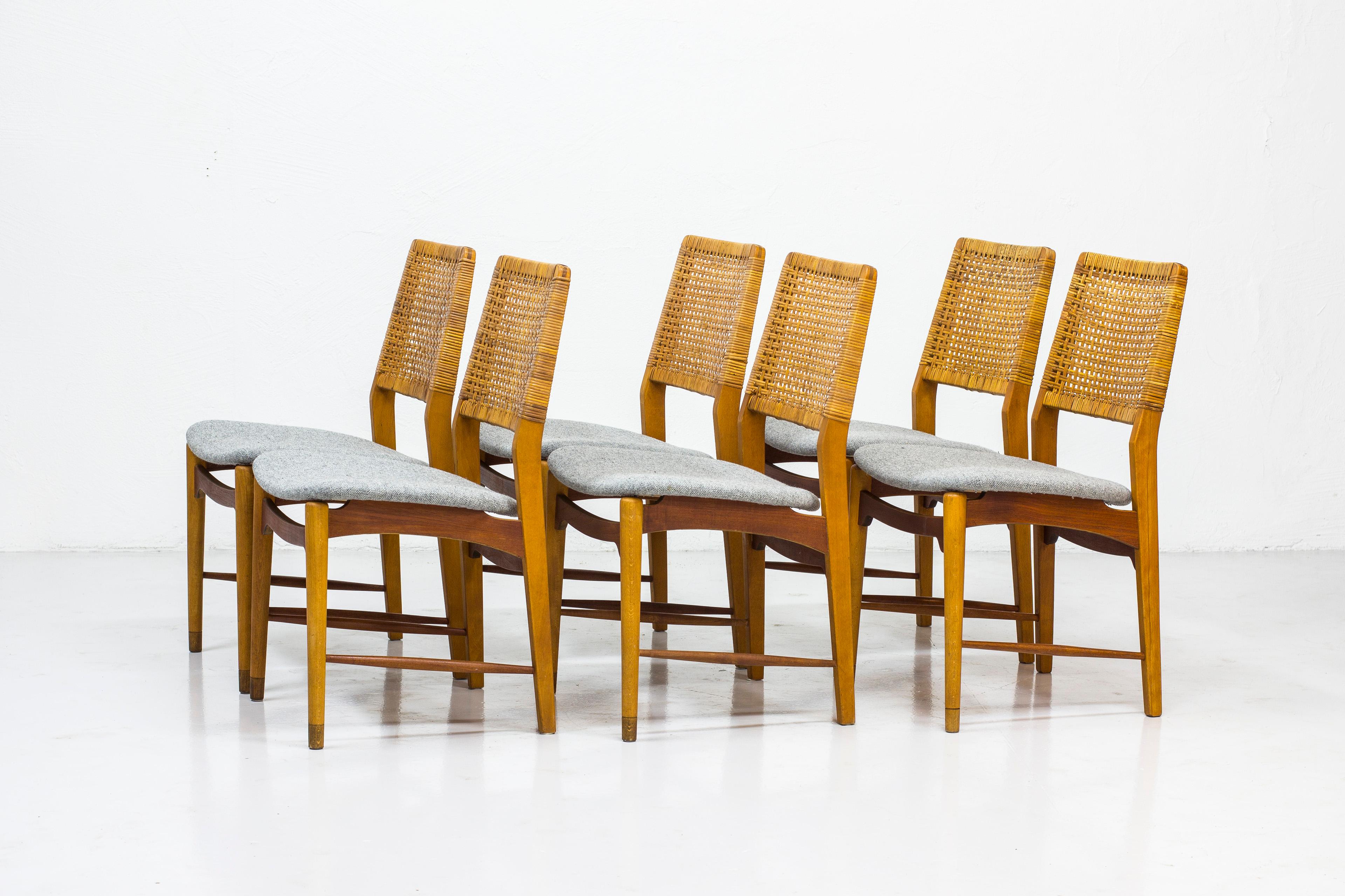 Set of six dining chairs made by Norwegian cabinet maker Alfred Sand. Made in Norway during the 1950s. Made from beech and teak. Back rest in rattan and seats reupholstered in grey 