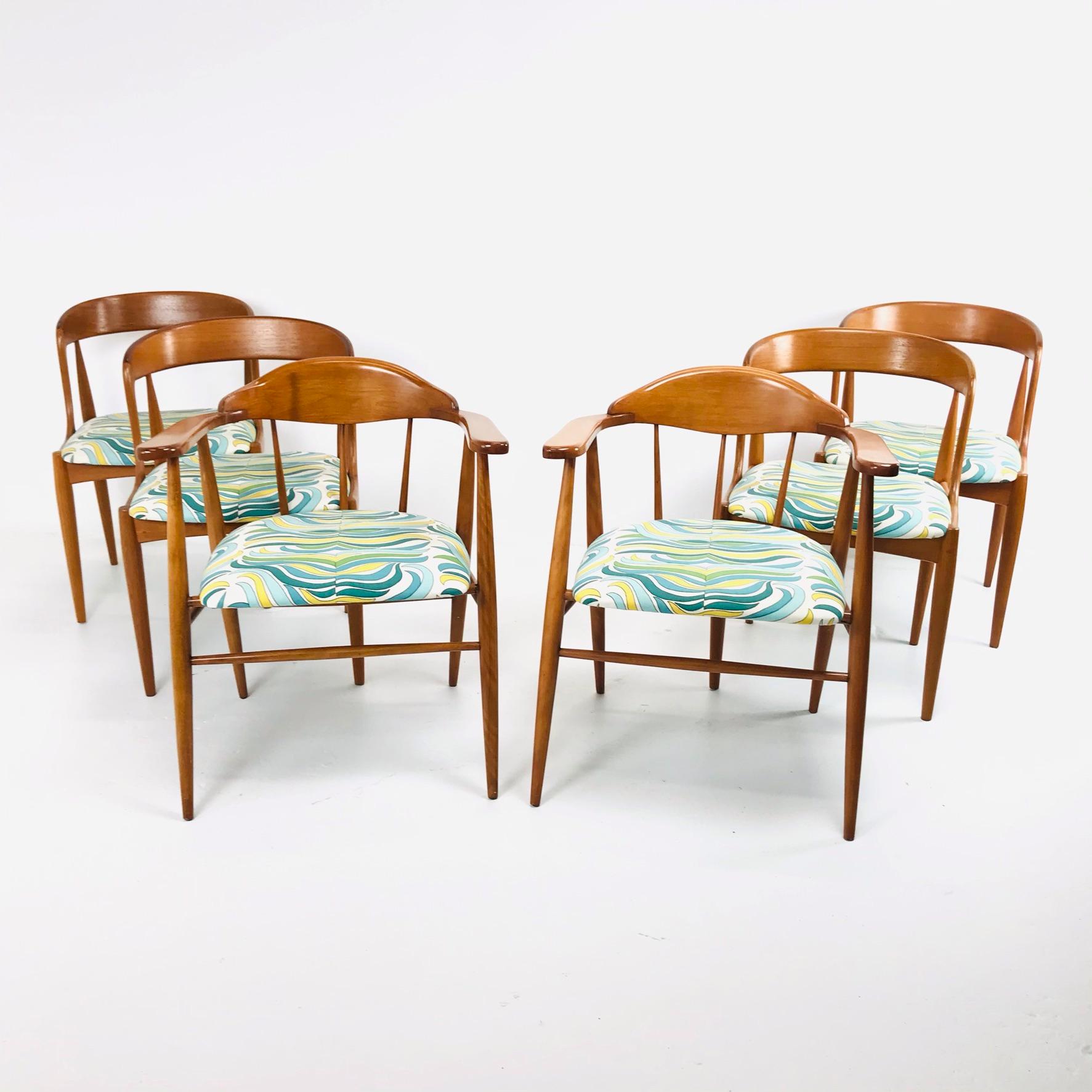 Set of 6 midcentury teak dining chairs. Includes 4 side chairs and 2 armchairs. Upholstery is in great condition and chairs are structurally sound. One chair has a break that has been repaired (pictured), otherwise set is in good vintage