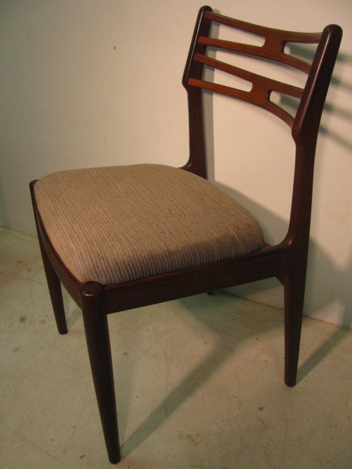 Elegant set of six teak chairs just recovered in a beautiful blue gray ribbed fabric. Pierced ladder back style delicately connects arched chair legs. All new foam padding with new material in that sixties style. One chair stretcher has a crack