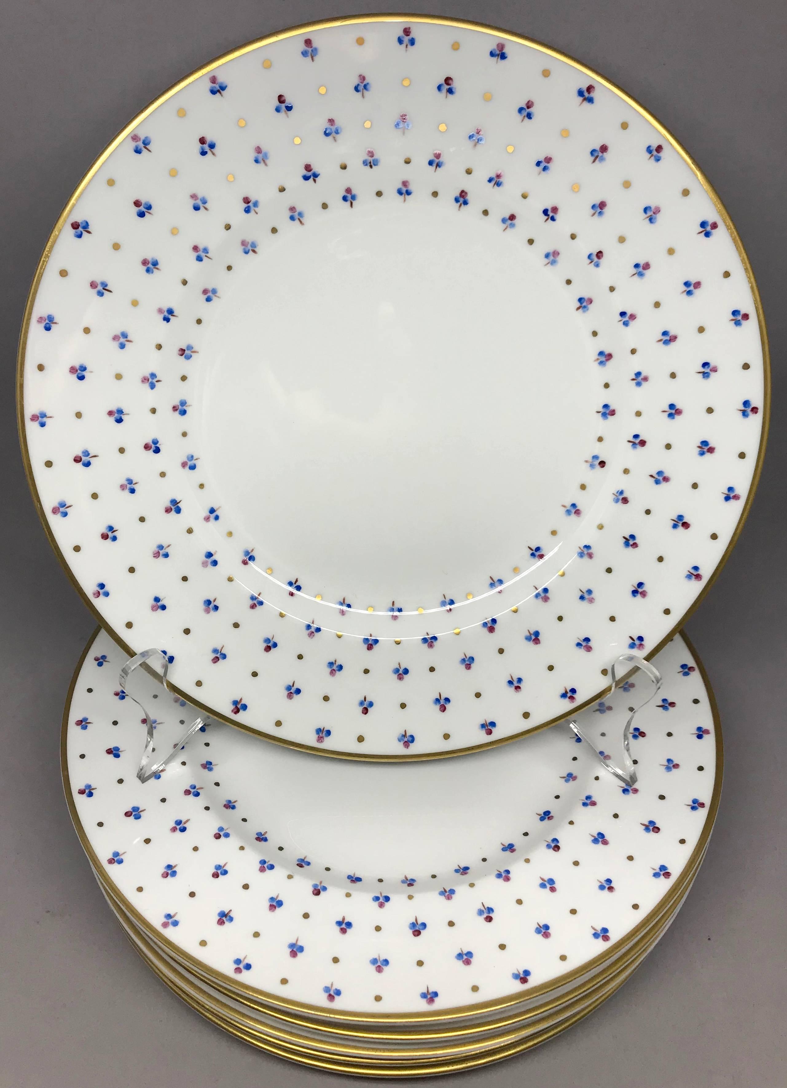 Set of six vintage Tiffany & Co. gold rimmed French plates. Six private stock gilt-rimmed dinner plates with blue and magenta floral sprigs, hand-painted in France. United States, mid-20th century.
Diameter 9.25