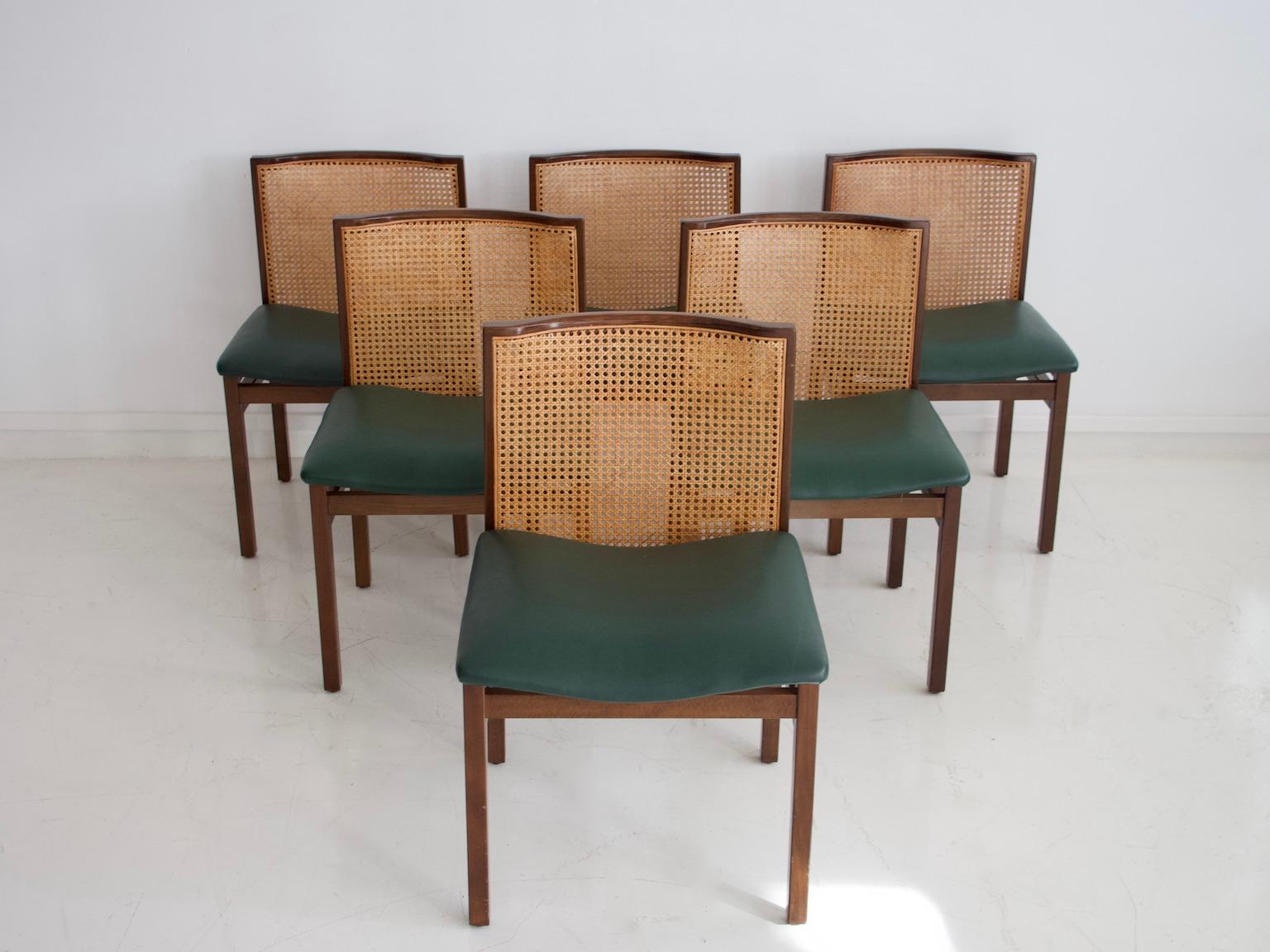 Six chairs with wooden frame, forest green leather seat and cane back by Tito Agnoli. Manufactured in Italy, circa 1957.

Literature: Giuliana Gramigna, 