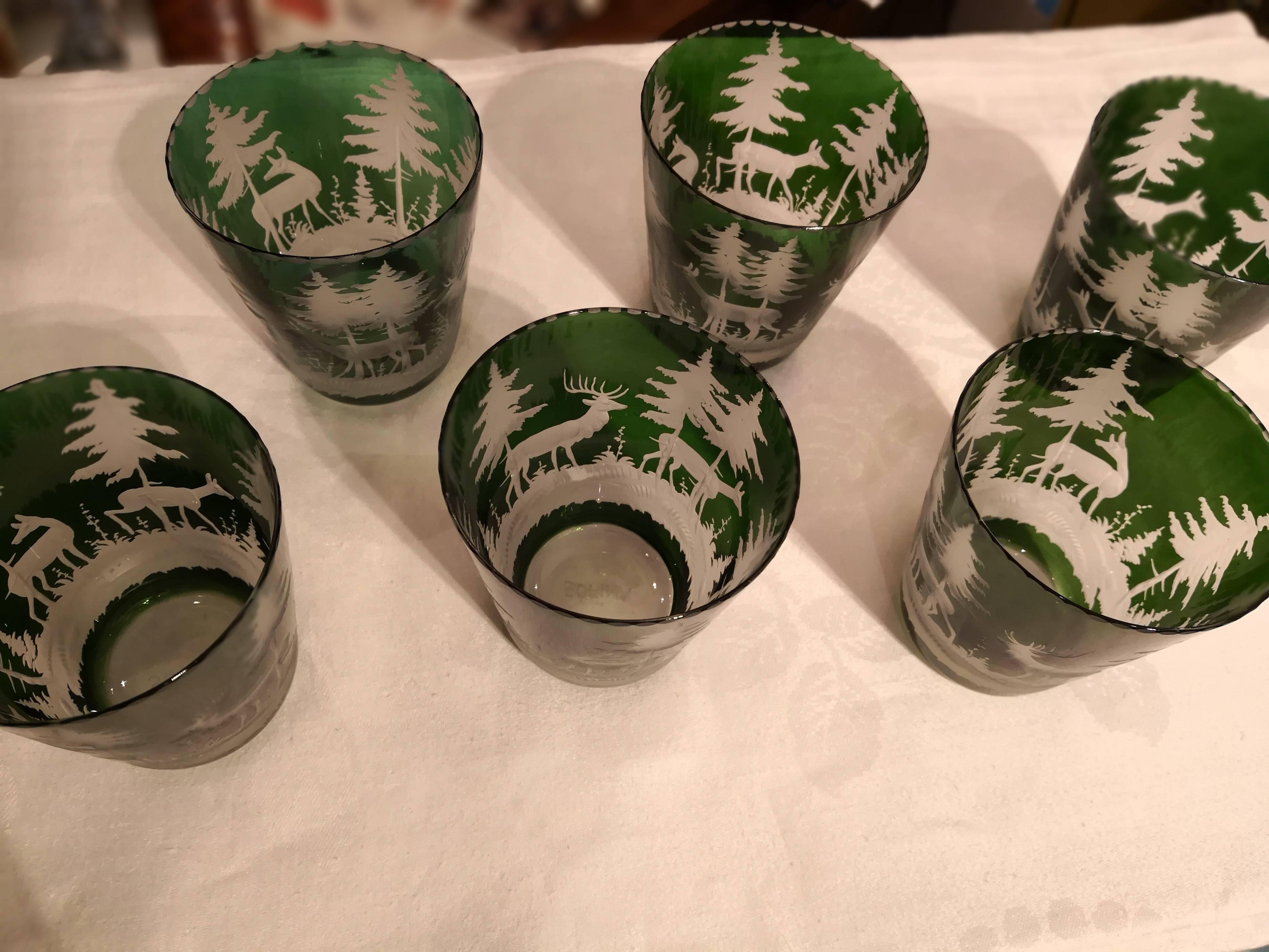 Set of six handblown green crystal tumblers with hand-edged hunting scene in the style of Black Forest. The decor is an antique decor with deers, trees and bambis all around. Completely handblown and hand-engraved in Bavaria Germany. The glass here