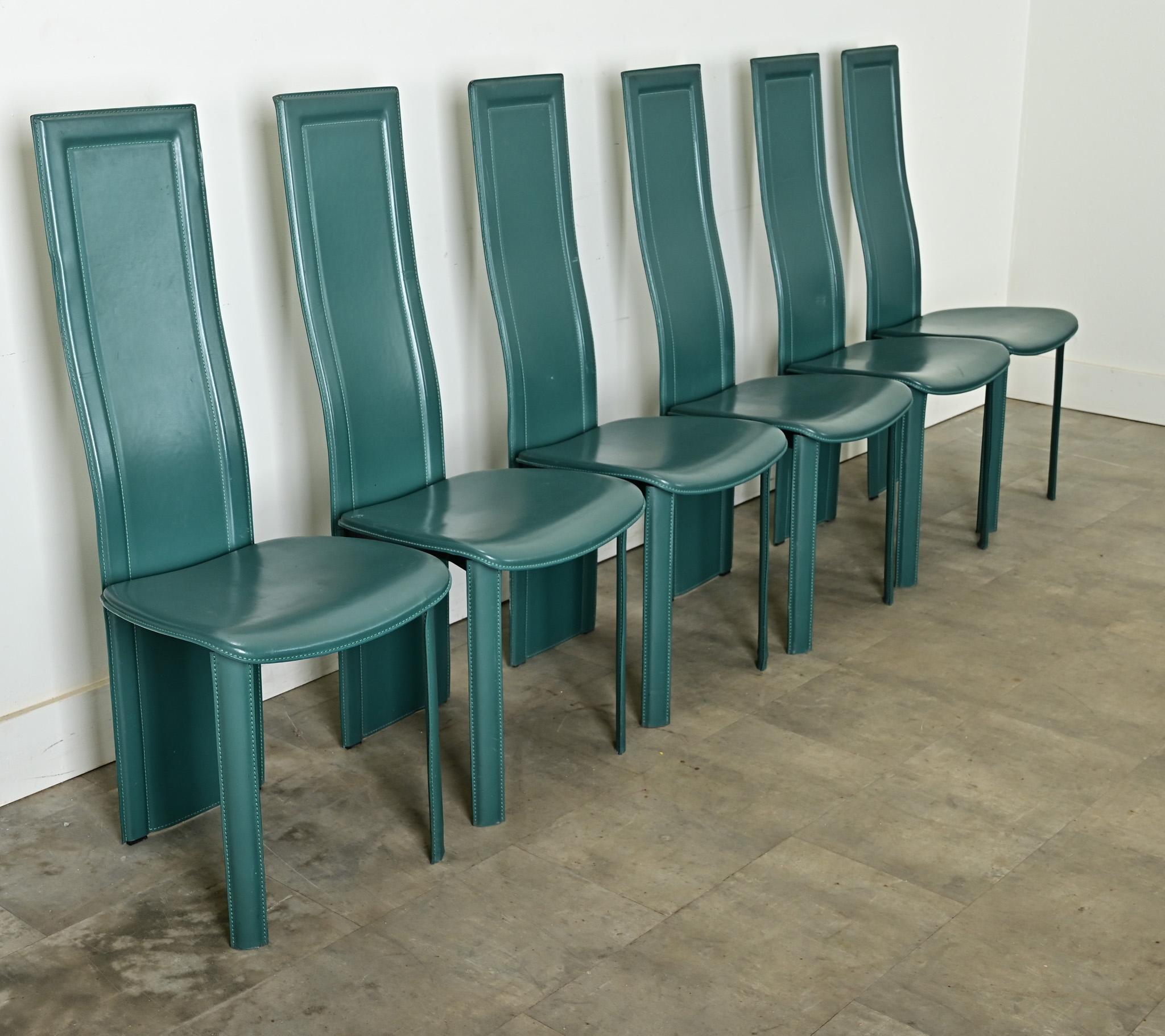 A very chic set of six postmodern dining chairs, circa 1980, in the manner of designer Pietro Costantini. No visible marks on these examples to say definitively. Made of thick, saddle leather in an eyecatching turquoise  hue, expertly tailored to