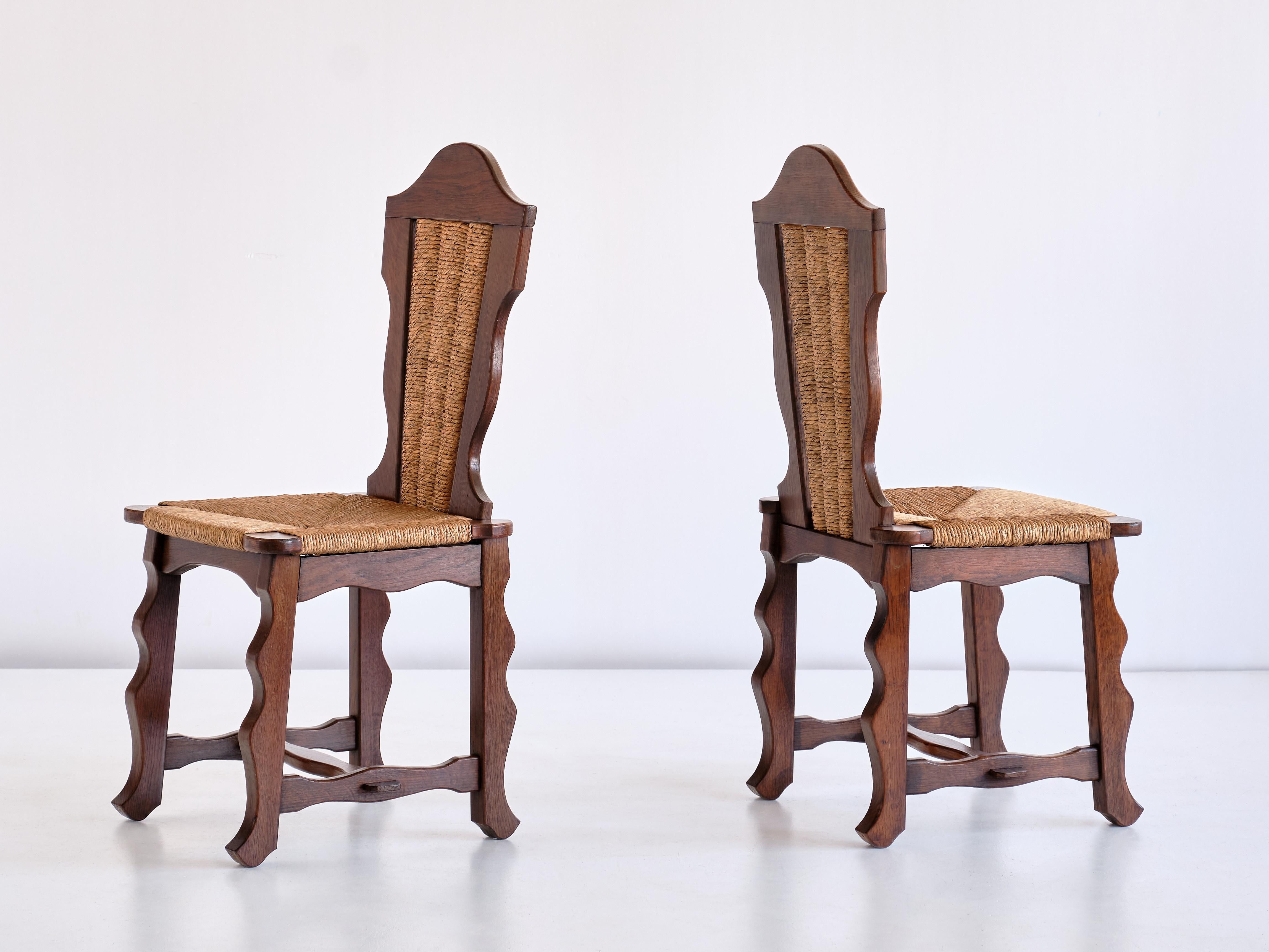 Français Ensemble de six chaises de salle à manger en chêne et jonc attribuées à Victor Courtray, années 1950 en vente
