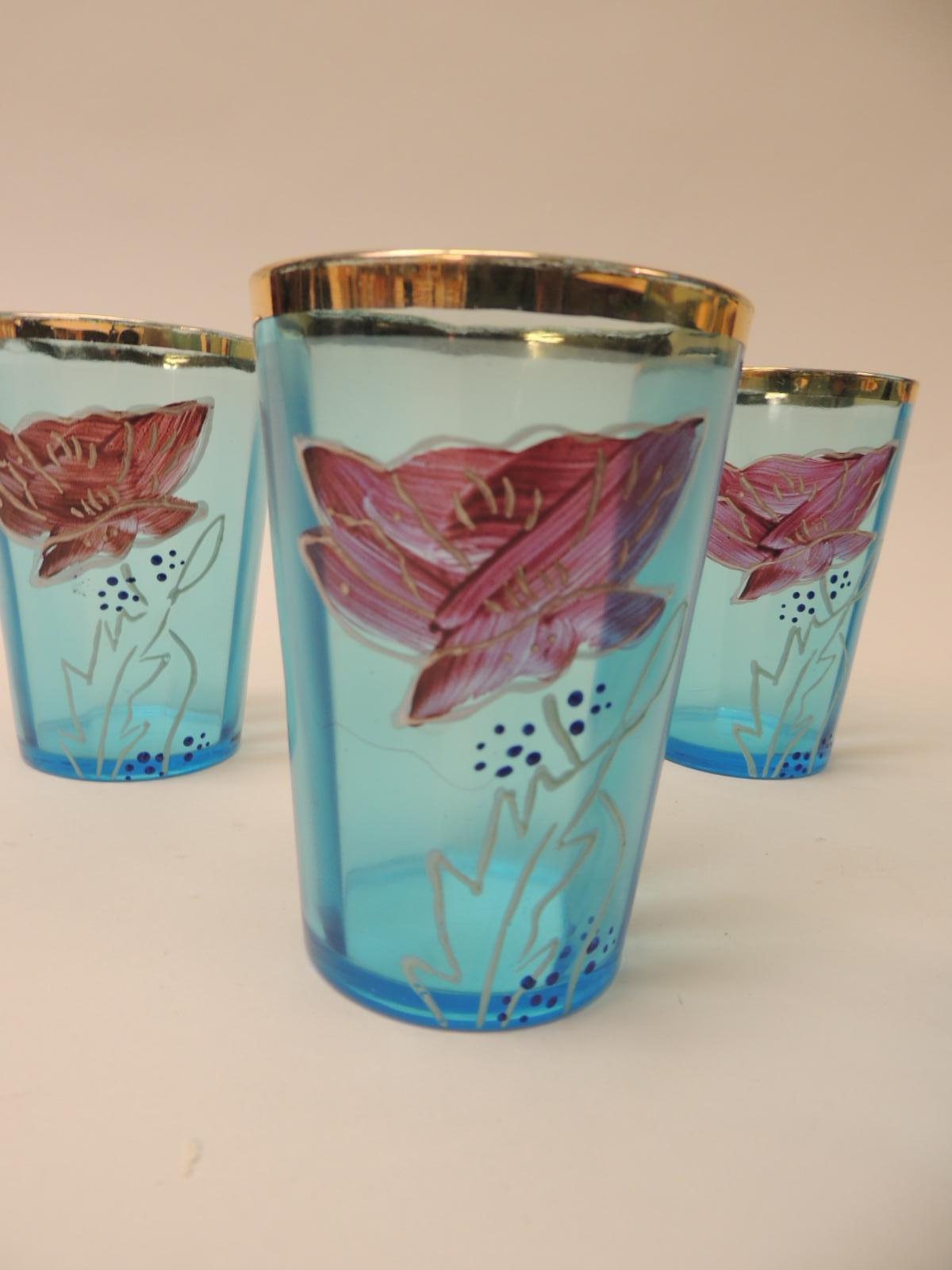 Set of six Victorian hand painted tea glasses
Each hand blown glass has a purple flower motif with a gold leaf rim edge in a tri-dimensional shape in turquoise color.
Size: 2.5” D x 4.25” H.
  