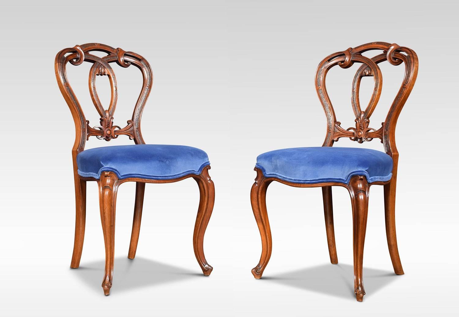 A set of six Victorian walnut dining room chairs with oval shaped backs having delicately cartouche and scroll carved crested centre, to the over-stuffed blue velvet seats, all raised up on shaped cabriole legs
Dimensions:
Height 34.5 inches,