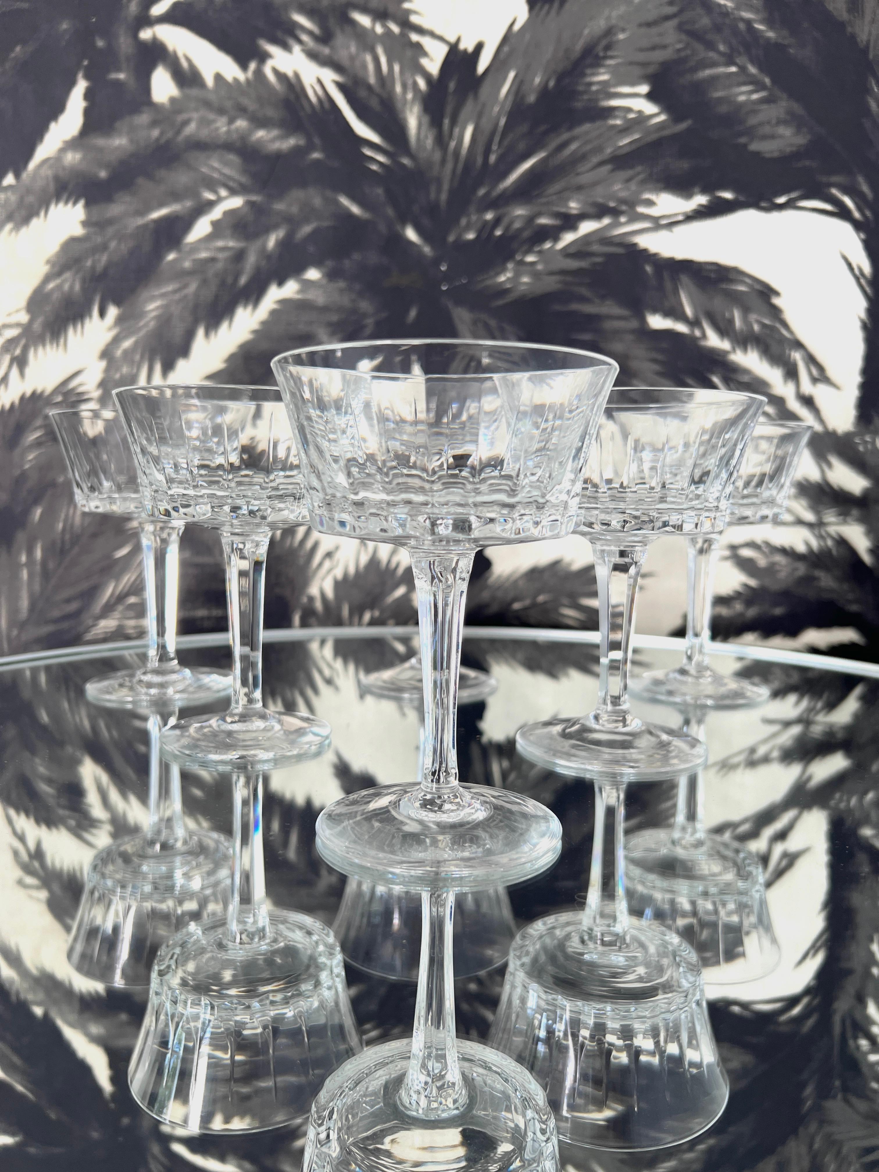Set of vintage crystal stemware by Gorham, c. 1970. The elegant blown glass champagne coupes feature etched vertical cuts along the bowls and have faceted multi-sided stems which reflect like prisms. The glasses have a beautiful weight to them and