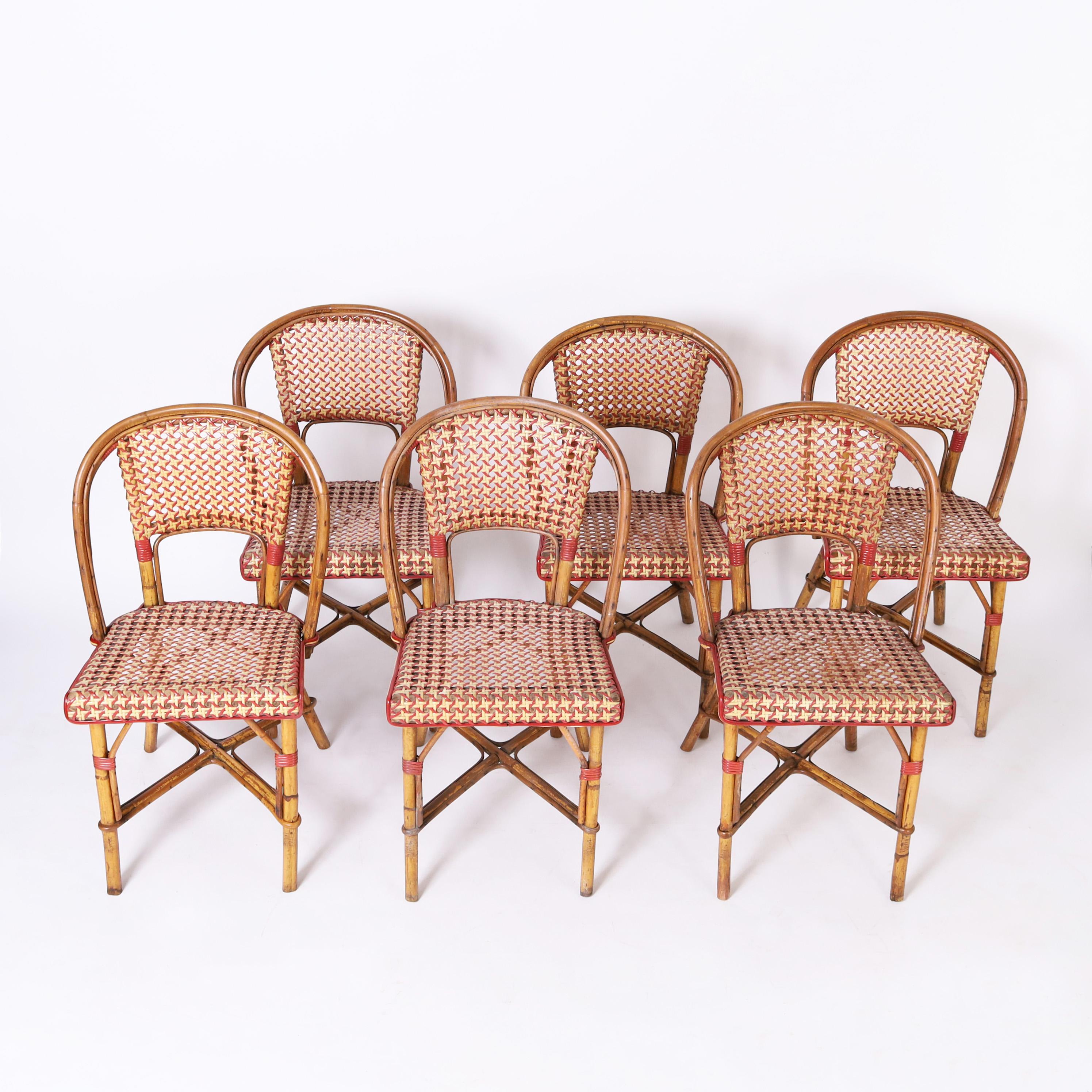 Charming set of six vintage French bistro chairs crafted in bamboo and bent bamboo with caned backs and seats decorated with painted reed highlights.