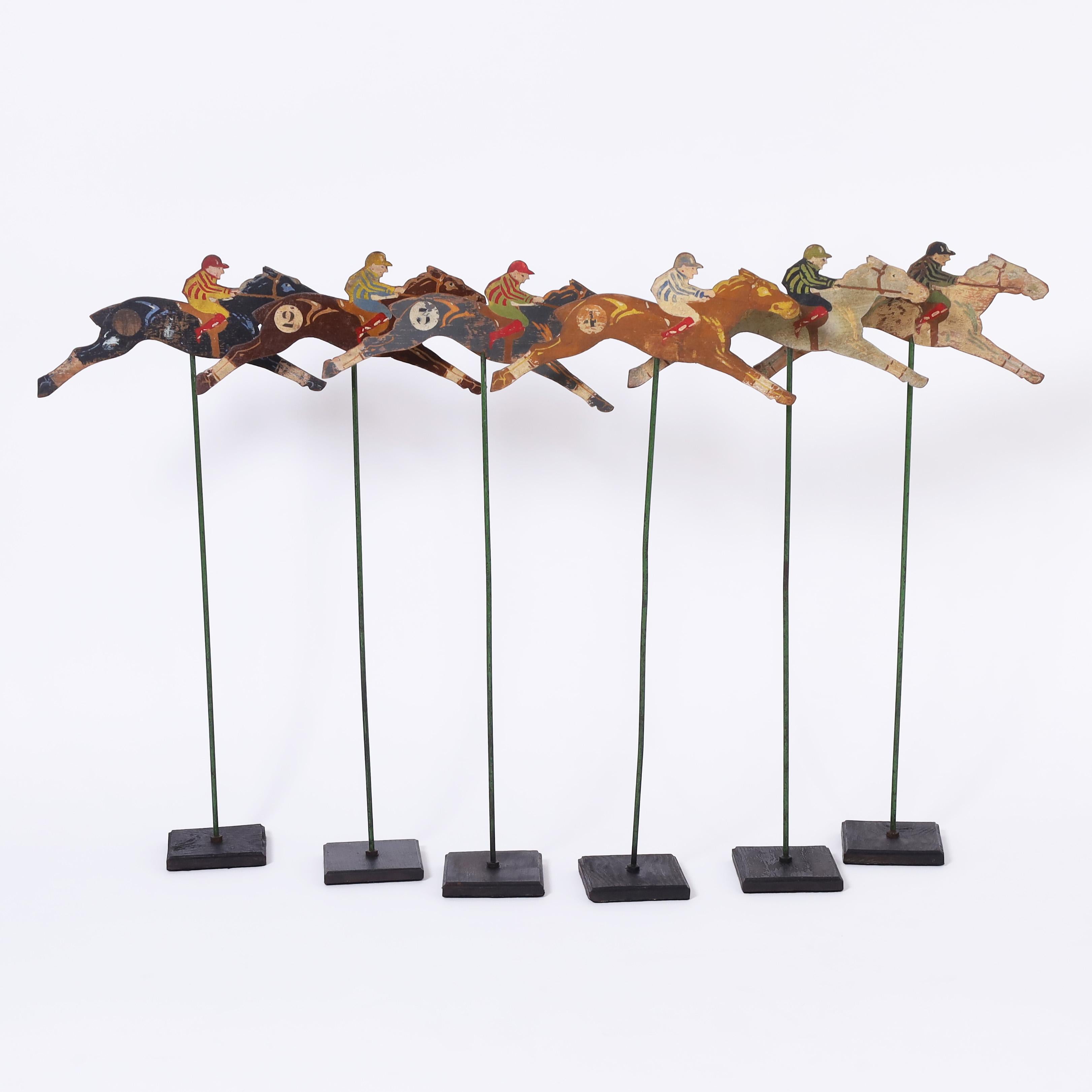 Charming set of six carnival game horse racing remnants crafted in wood, hand painted and numbered. Presented on wood bases. Place your bets.