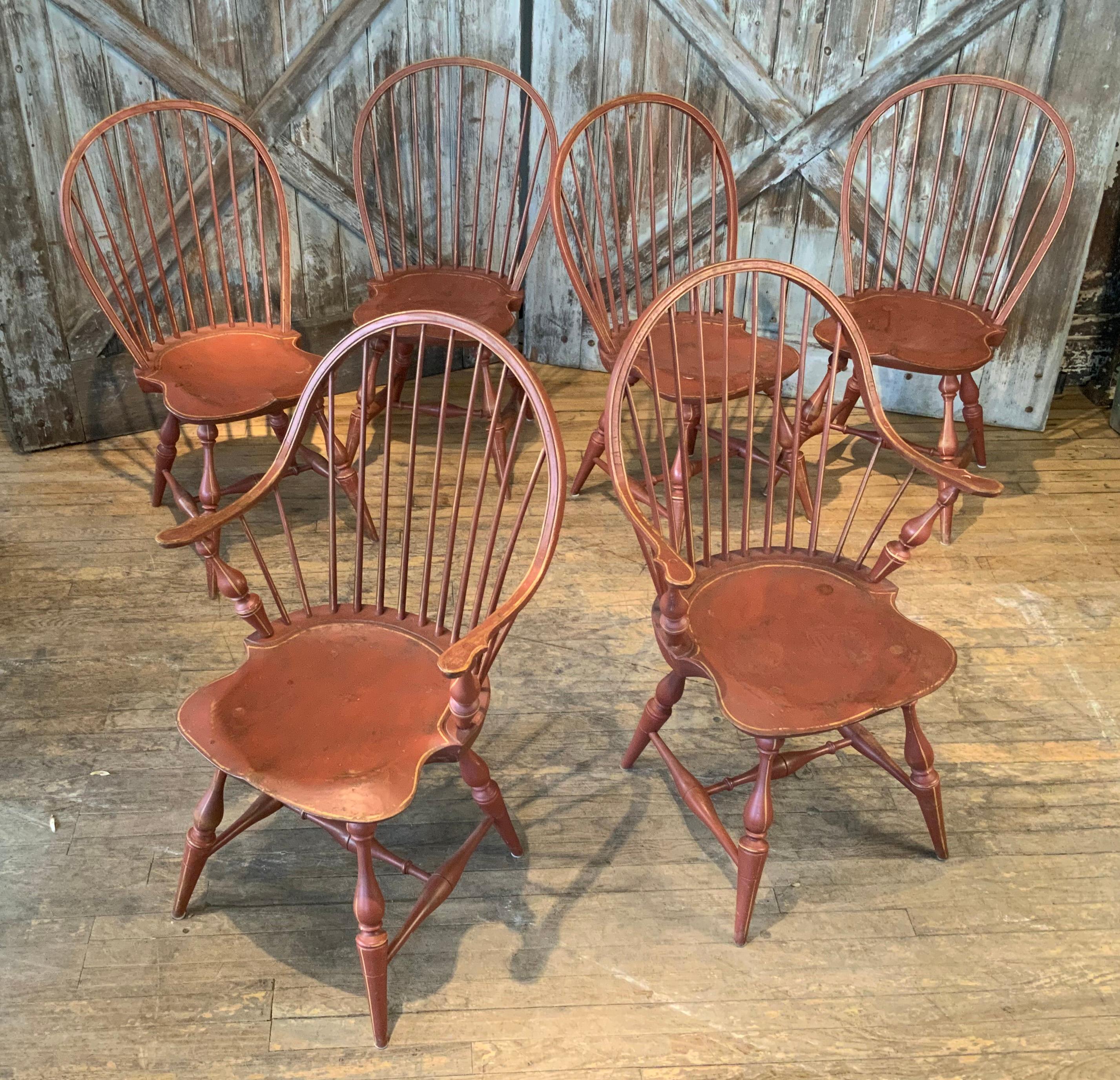A very well made set of six Windsor dining chairs, including four side chairs and a pair of generous armchairs, circa 1960's, in their original redwash finish. these are beautifully made with nice proportions and details. in good condition overall