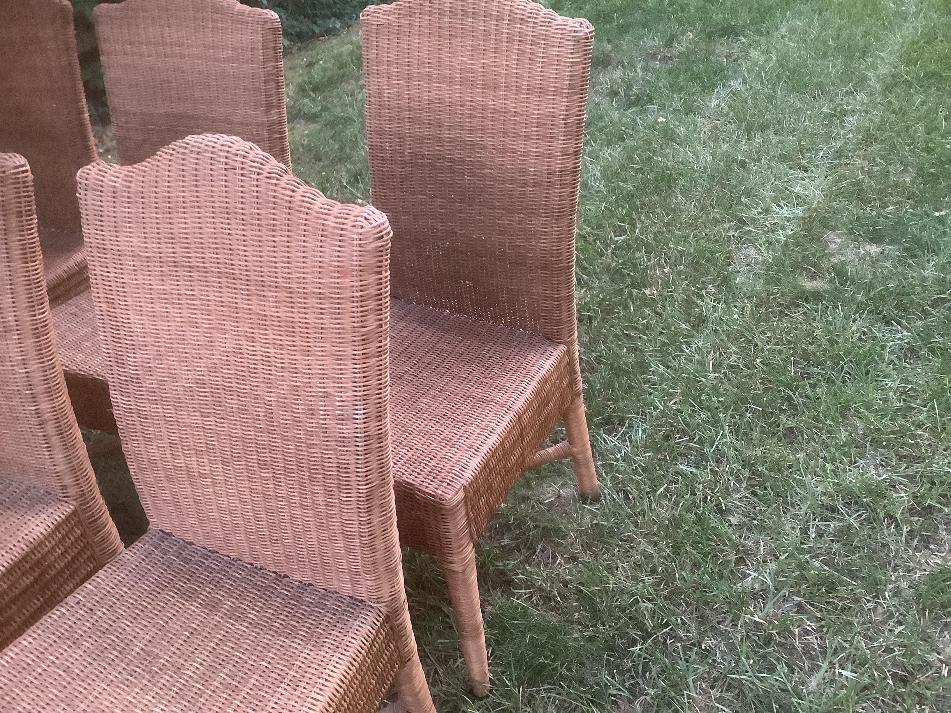 Set of Six Vintage Woven Wicker Dining Chairs. Each with an arched back and cross stretchers at the bottom of the legs to keep the frame of the chairs tight and secure. In good vintage condition with minor losses to wicker.