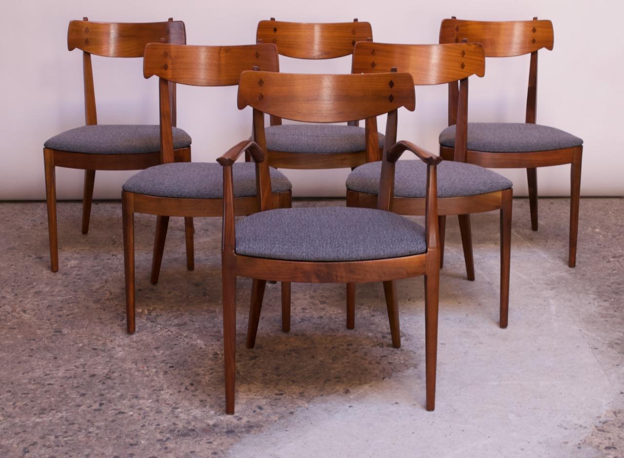 Set of six dining chairs (5 side, 1 captain) designed by Kipp Stewart for Drexel’s “Declaration” line (USA, circa 1950s). Composed of solid walnut frames with tapered, flared legs. Decorative 
