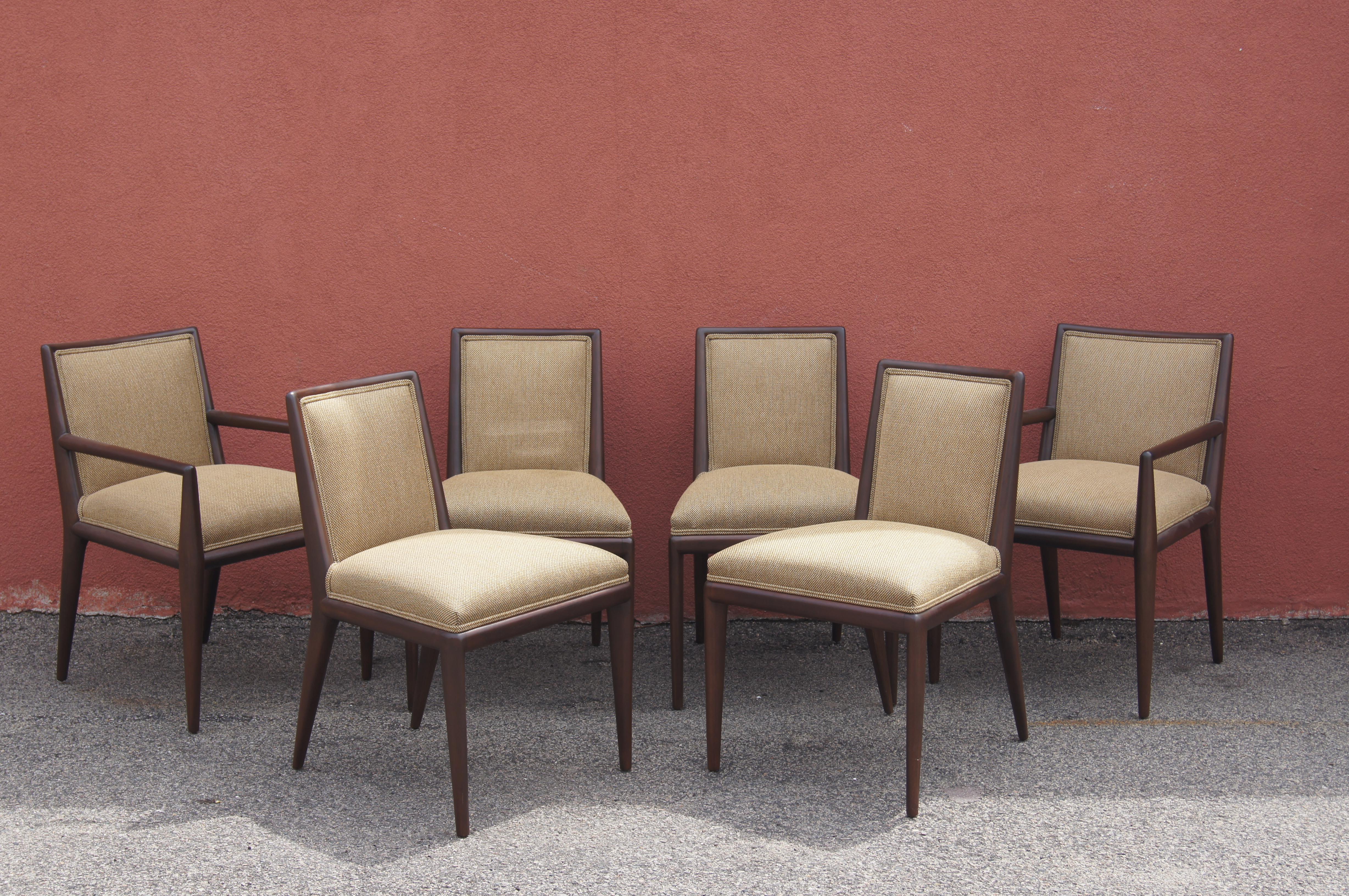 T.H. Robsjohn-Gibbings designed this elegant set of six dining chairs for Widdicomb. The slender walnut frames feature canted legs, tapered backs, and comfortable seats. The chairs have been newly reupholstered in a woven Knoll textile that blends