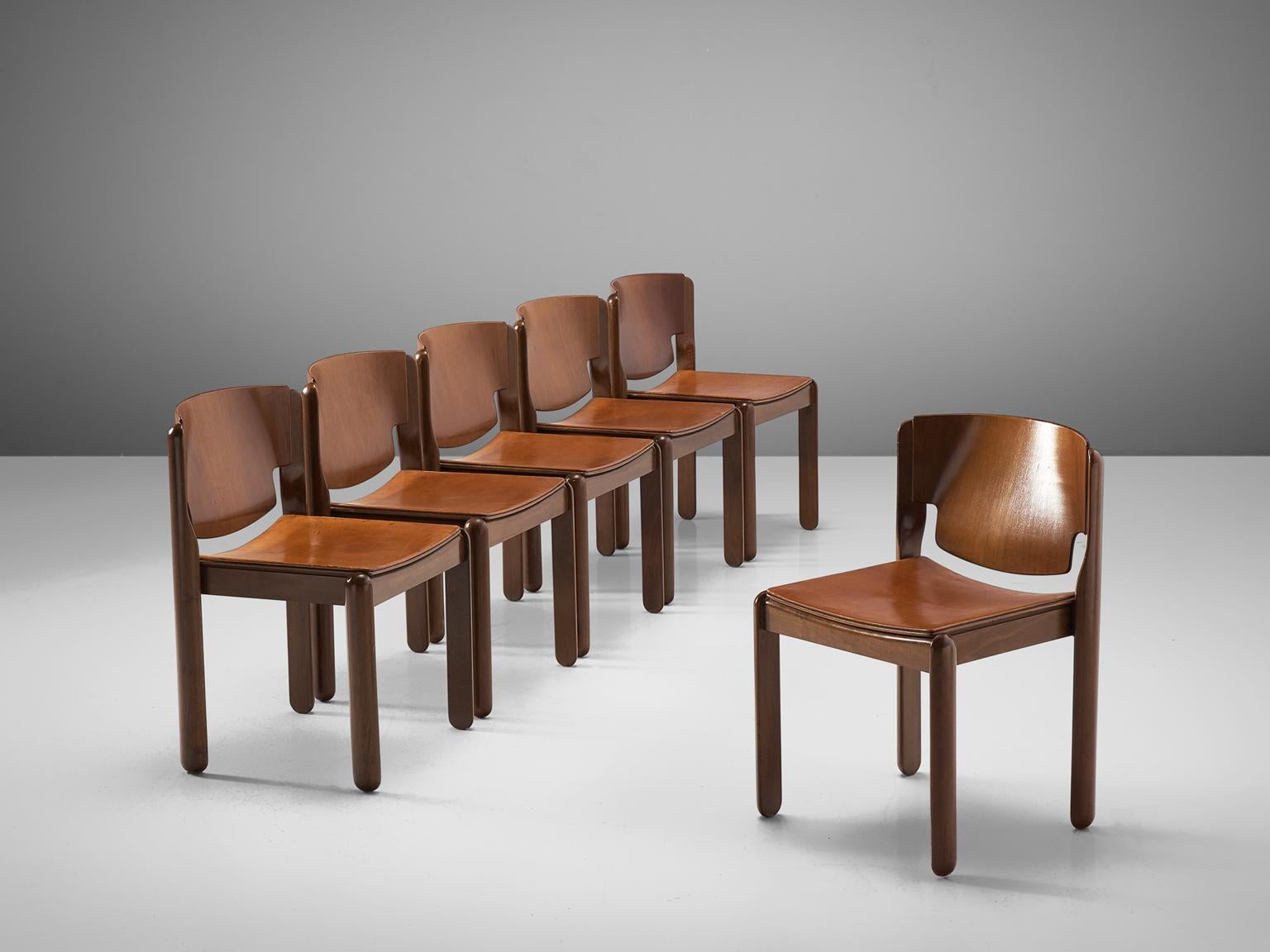 Vico Magistretti for Cassina, set of 6 dining chairs, walnut and leather, Italy, circa 1967.

Sculpted set of 6 dining chairs, designed by Vico Magistretti. The chairs feature half cylindrical legs, that are rounded at the ends. Constructed in