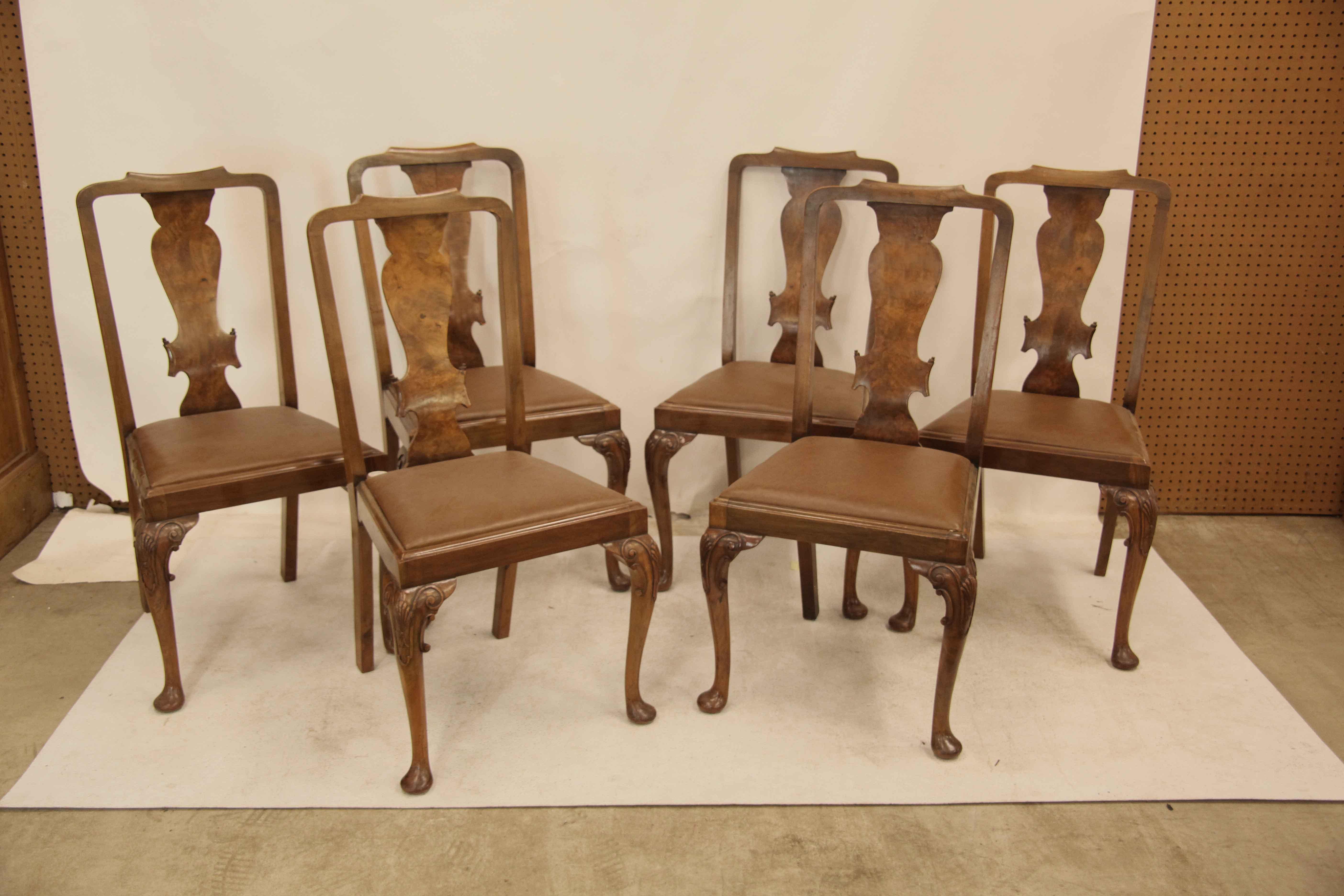 Set of six walnut  Queen Anne chairs, with nicely shaped crest rail, the splat with burl walnut veneer, slip seats are upholstered with tan leather and are in good condition. The front cabriole legs feature a carved shell on the knee and ''C''