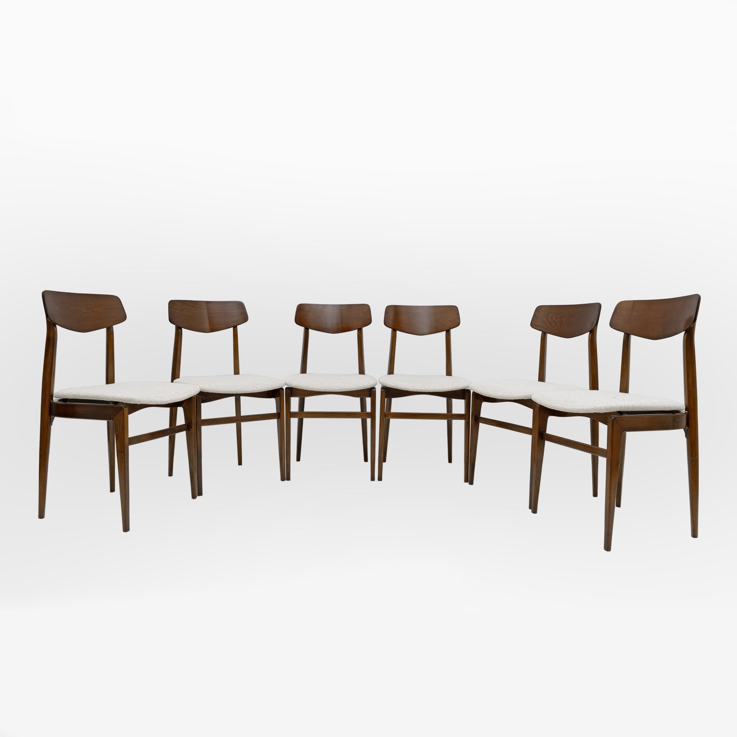 Set of six dining chairs, in walnut-stained beech and Bouclè fabric covering, Denmark, 1960s

Highly elegant chairs that would appear gracefully around the dining or conference table. The sharp and sculpted backrest is supported by two upright legs