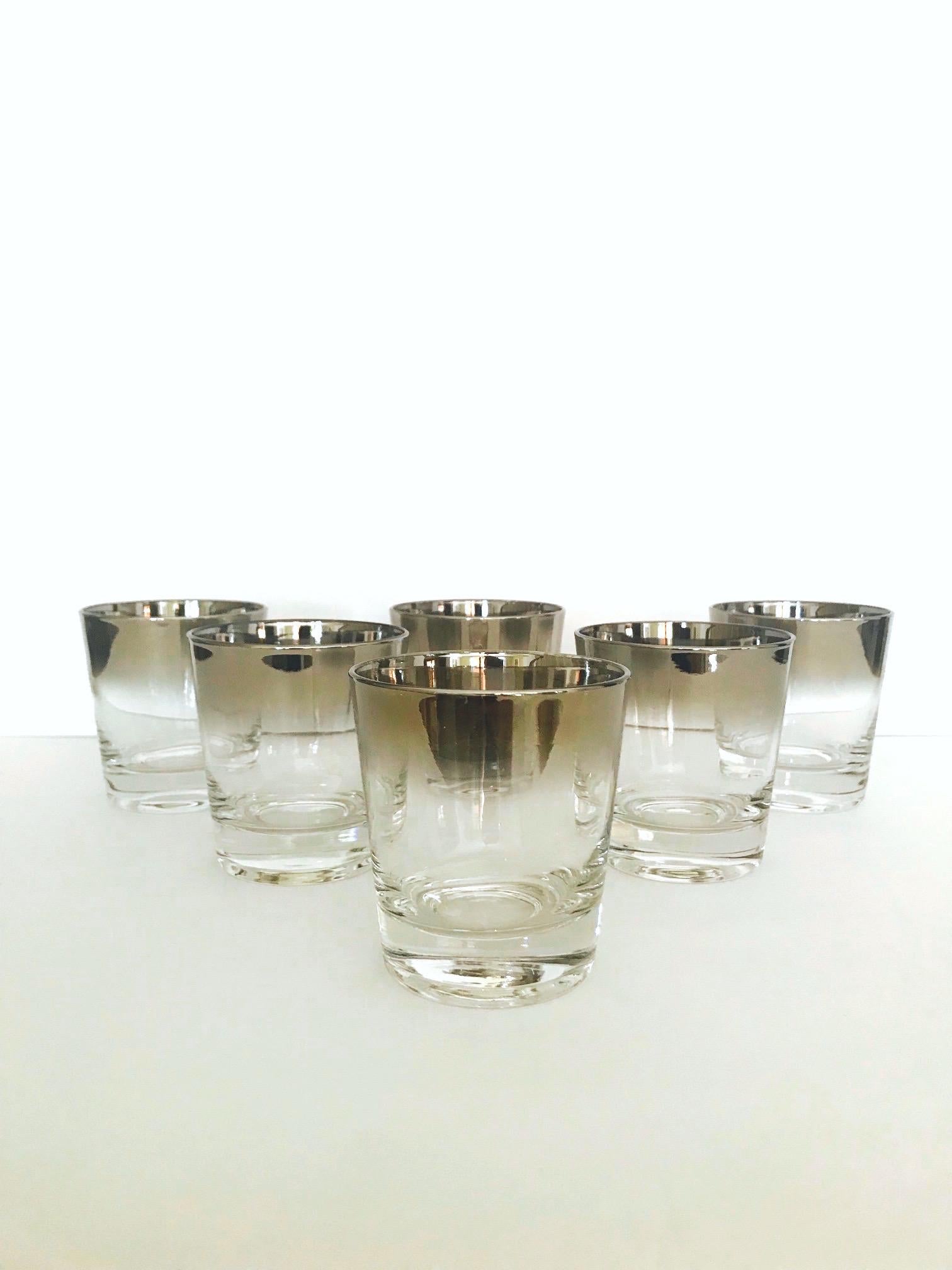 Iconic Mid-Century Modern barware set with silver fade overlay design. Great looking rock glasses with tapered forms and gradient hues of gunmetal along the rims. Set conveniently includes an extra glass for an actual set of 7.
 
  