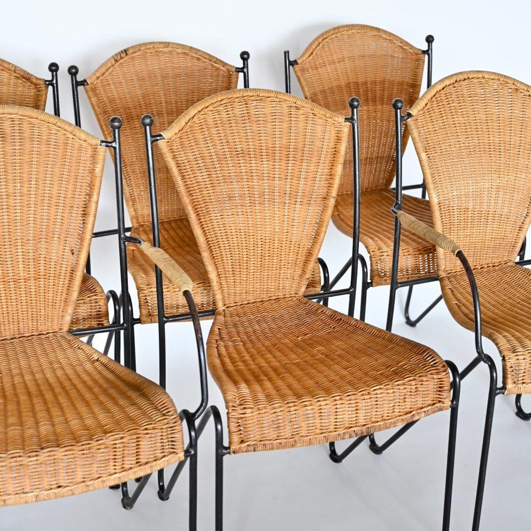Set of six Frederic Weinberg wicker and wrought iron chairs. Two armchairs and four side chairs. Sold as a set. USA, 1950's. Wicker has been recently repaired and reinforced. One finial missing at one side chair. 