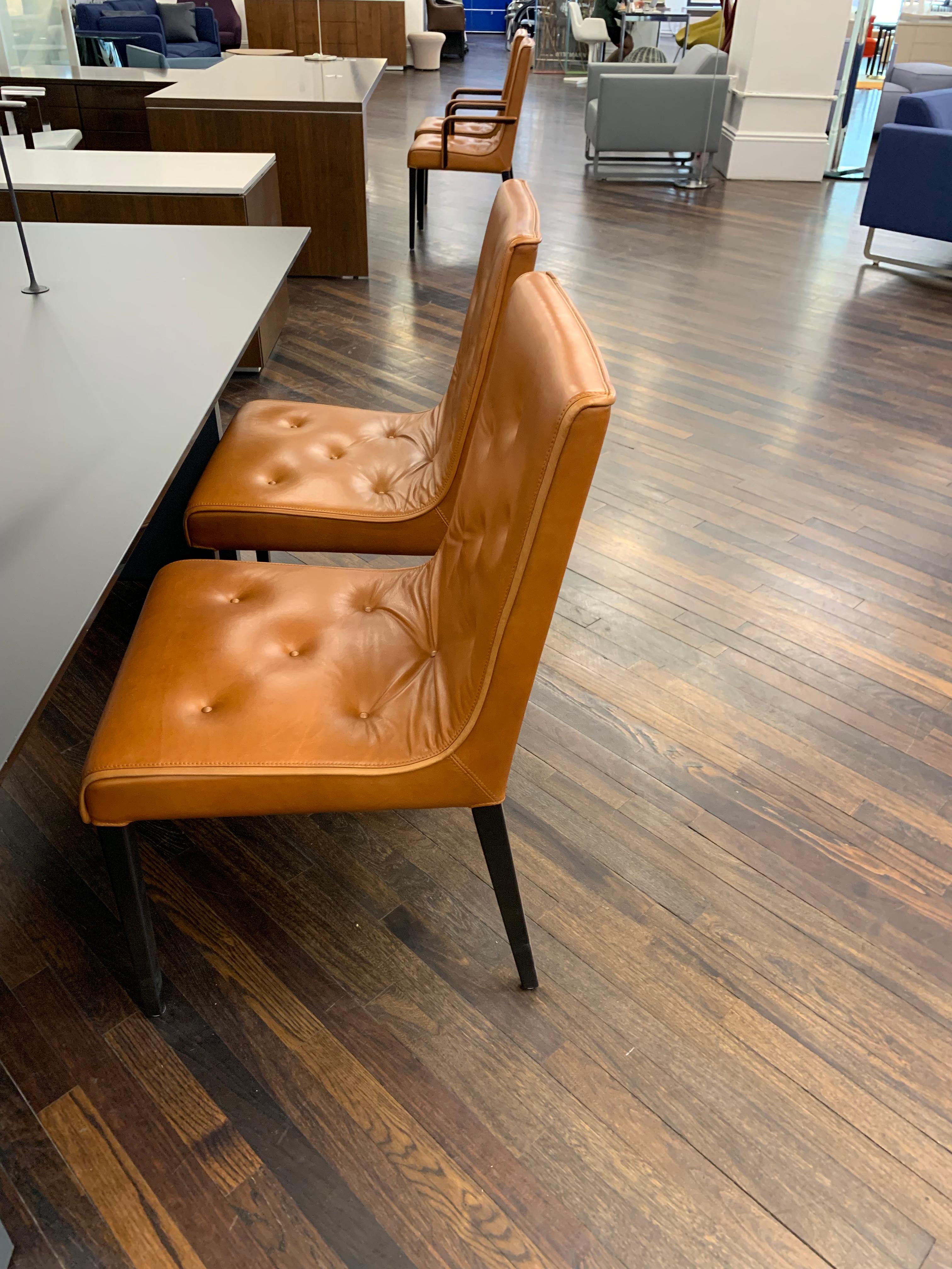 Upholstered in natural leather brandy
Base/ armrests: Bleech black stained 
Original price: $ 15,230
Leslie’s signature design element is a soft, upholstered mat that appears to be laid loosely on the furniture, though in reality it is