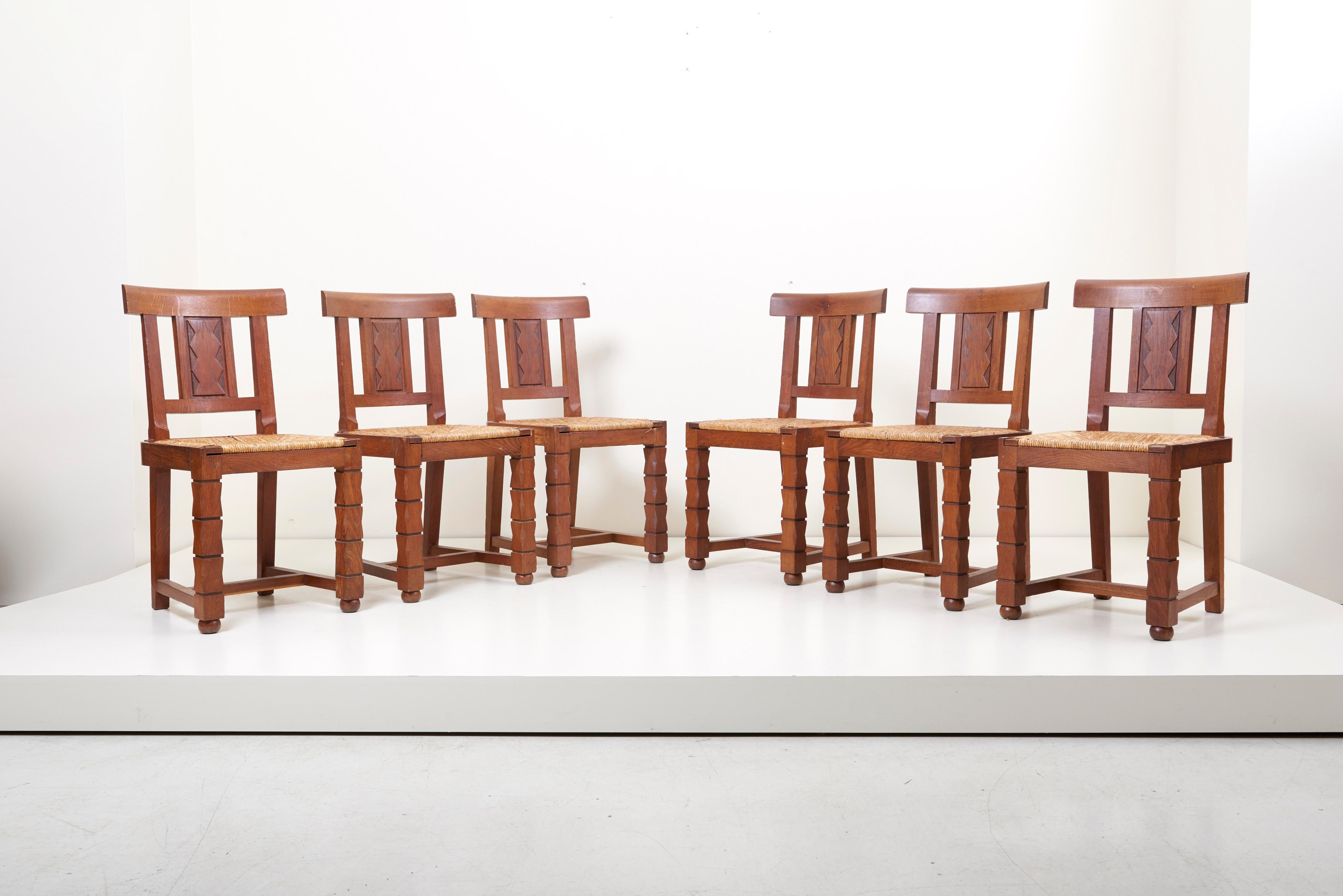 Set of six French 1930s wooden chairs in oak by Jacques Mottheau (1899-1981).