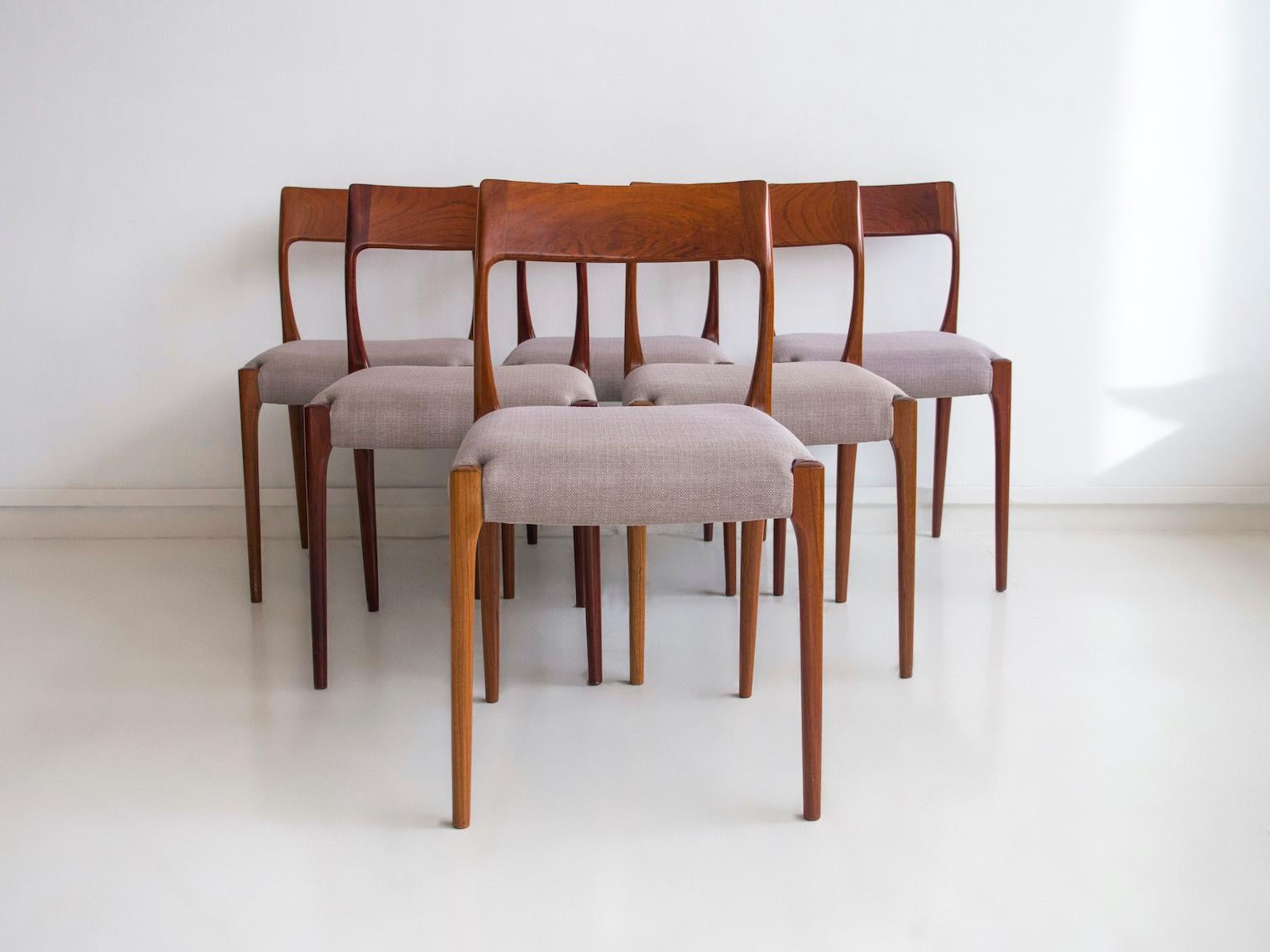 Set of six chairs made in Denmark in the 1960s-1970s. Backrest and feet in teak, seats upholstered in light grey fabric. Reupholstered at a later date.
