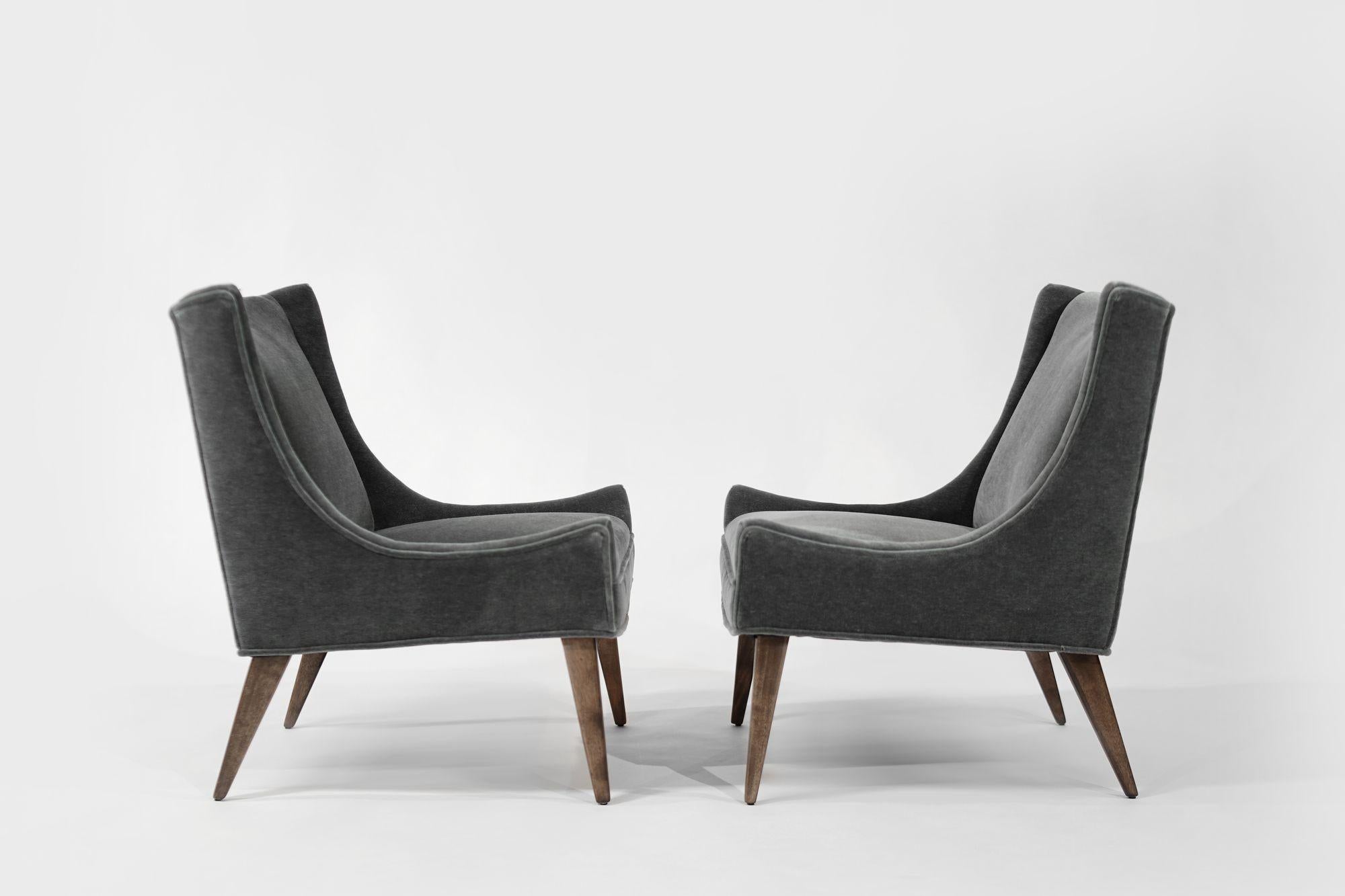 A stunning pair of slipper chairs by Selig, circa 1950s, boasting elegant bronze handles and tapered walnut legs. Fully restored and newly upholstered in luxurious gray-blue mohair, these chairs offer a perfect blend of mid-century style and modern