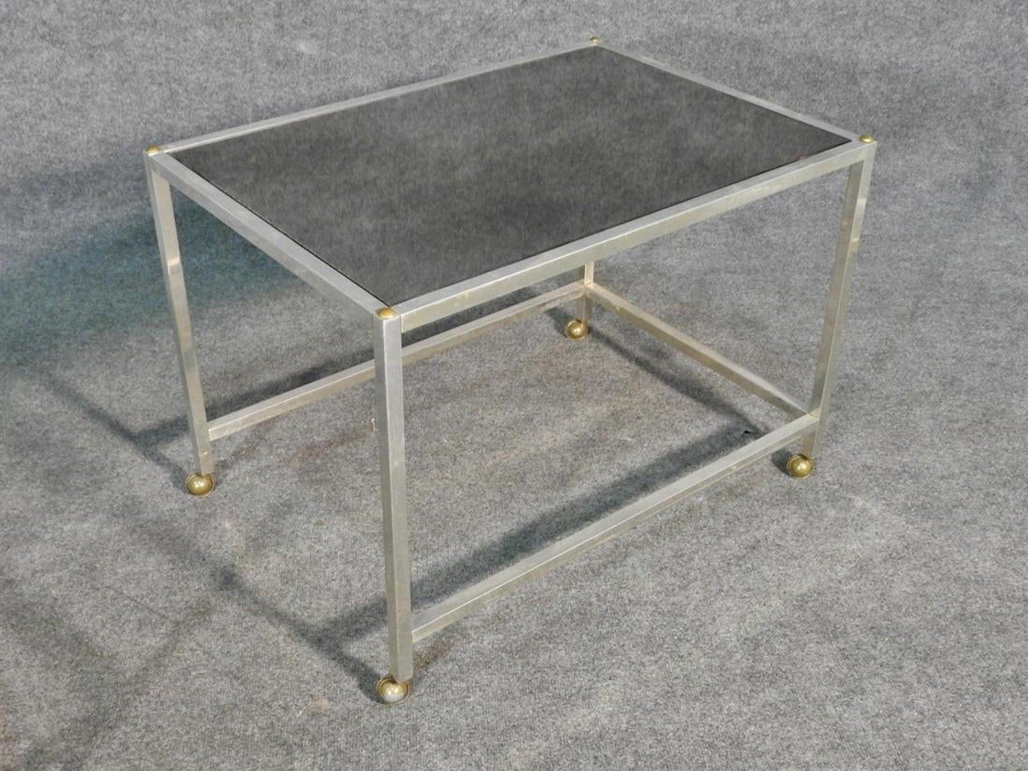 Mid-Century Modern nesting tables with metal frames and blackened glass.
(Please confirm item location - NY or NJ - with dealer).
  
