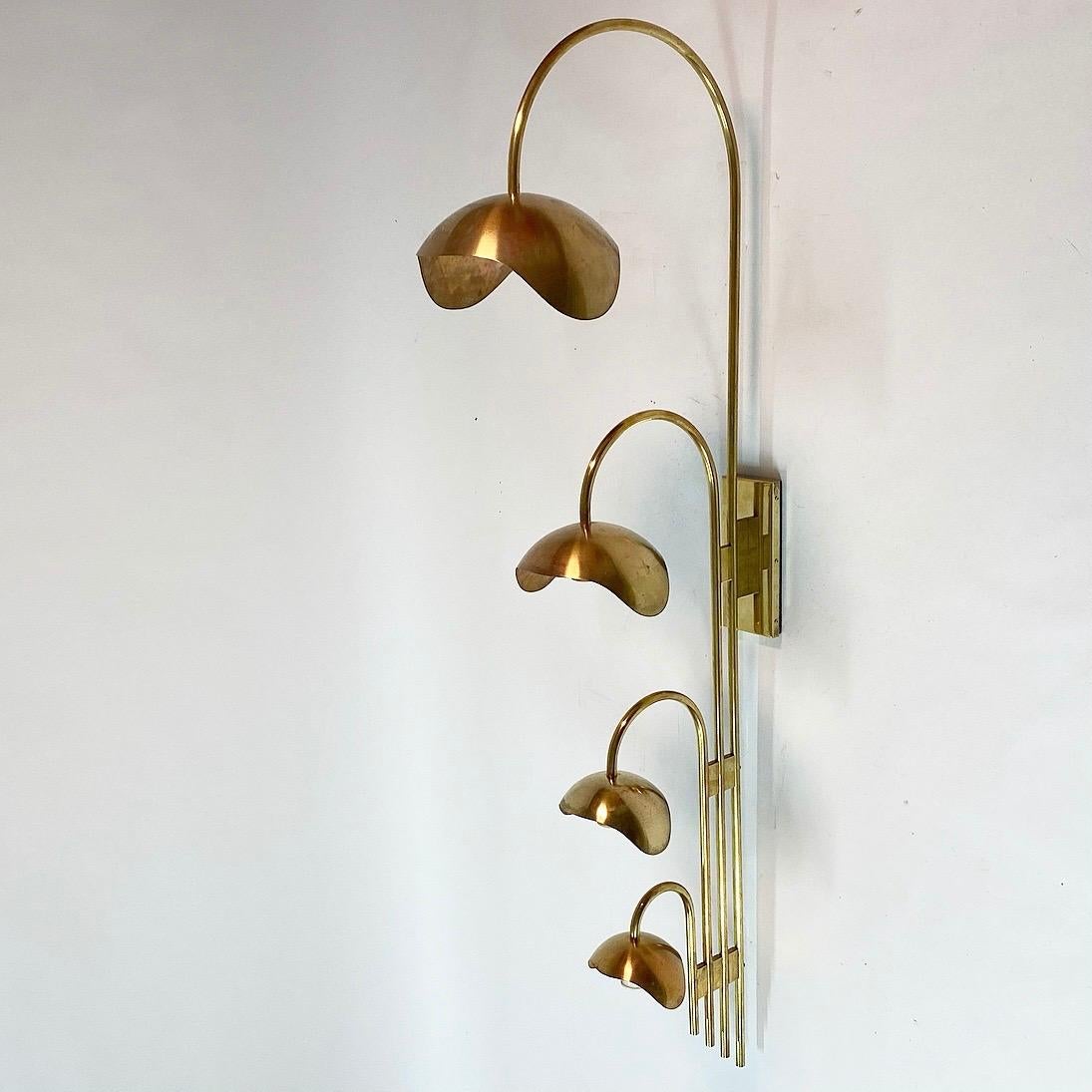 Elegant, majestic and huge in size is this solid brass wall sculpture with four-light sources. 

Almost certain that this lights was designed by Palle Suenson in the 1940s. 

Palle Suenson, renowned Danish architect in 19th century made lighting