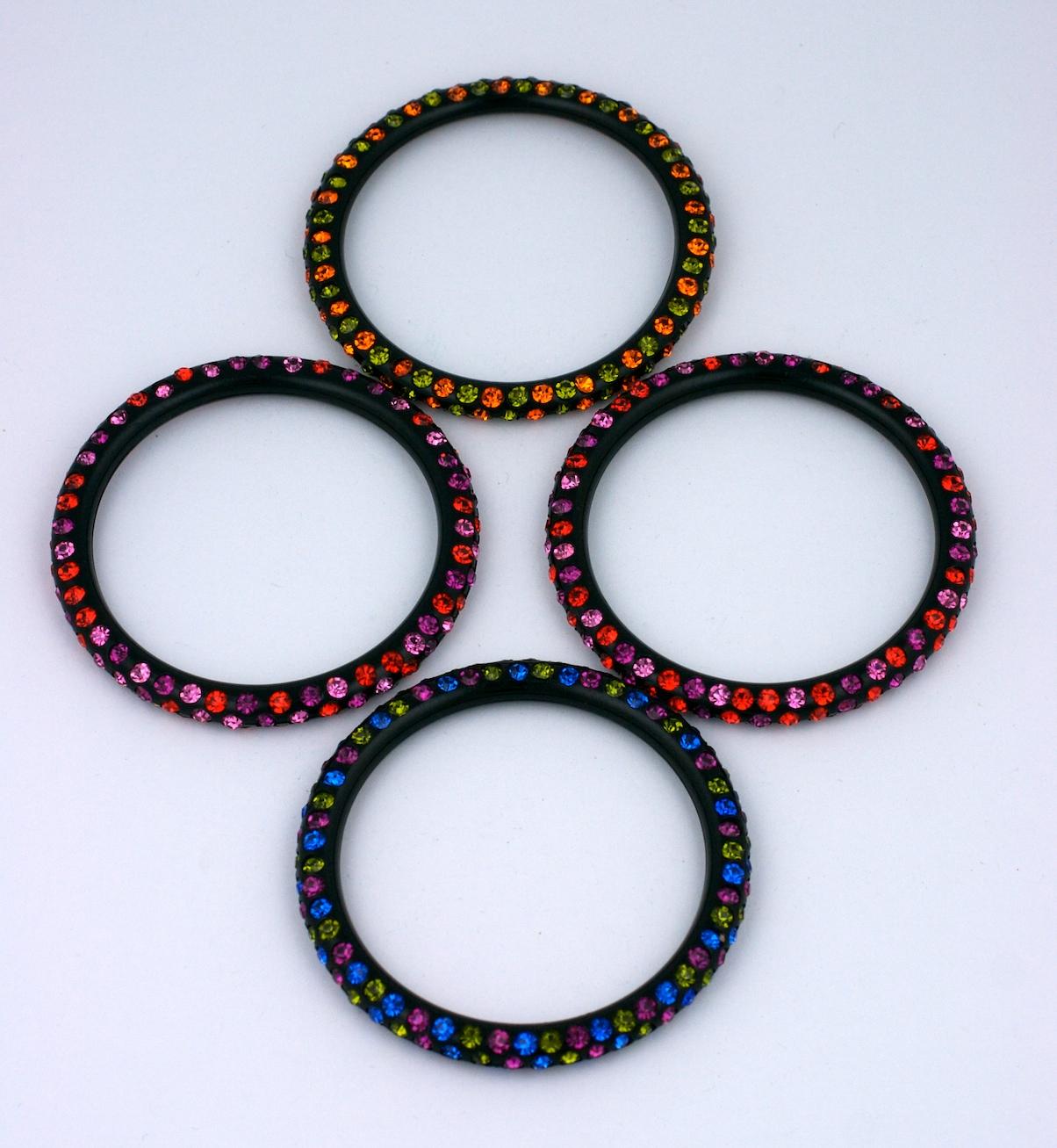 Set of 4 sparkle bracelets from the 1980's. Colored crystals set in bakelite like plastic. Great stacked or worn alone. Very interesting and versatile color ways. 1980's USA. 