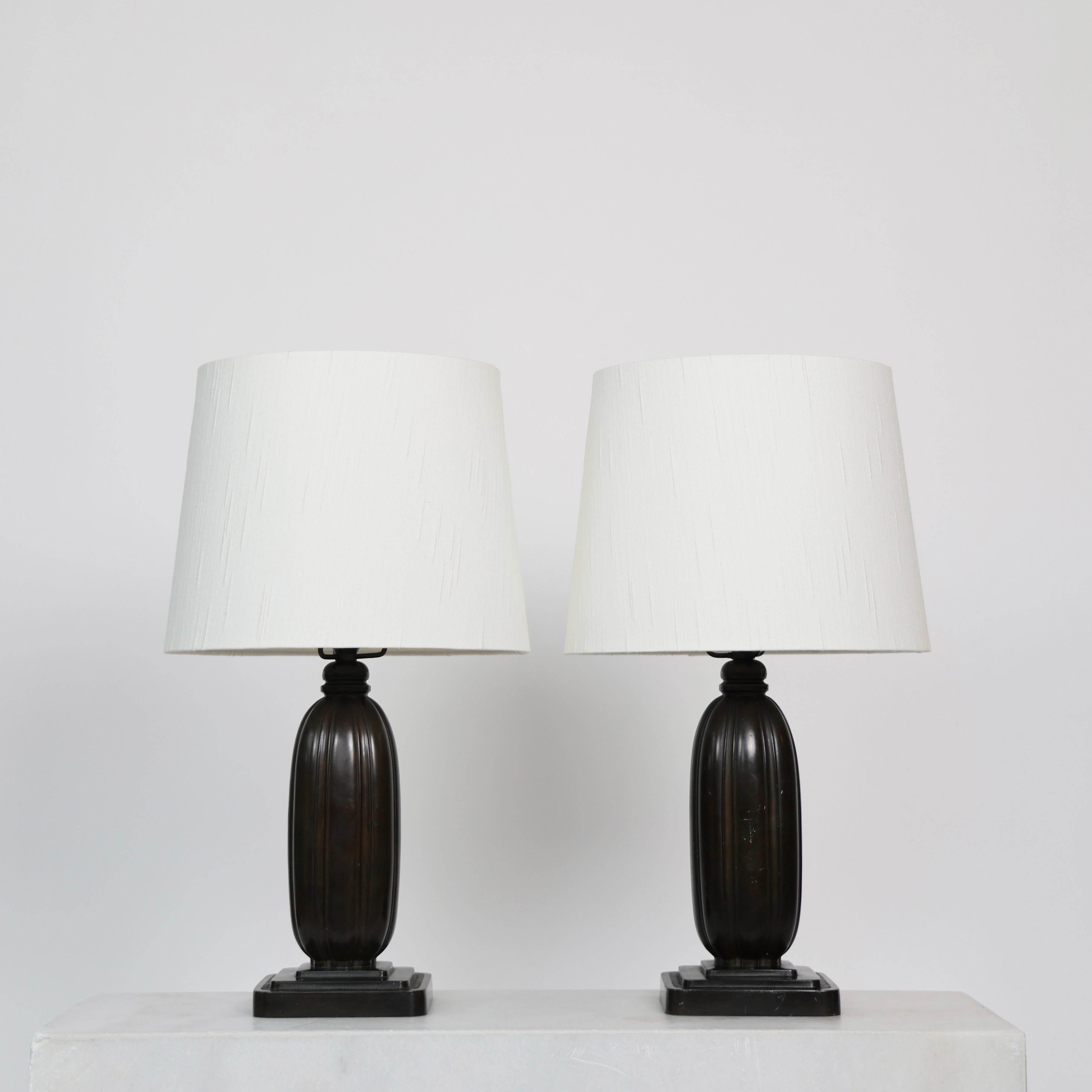 Set of Classic Diskometal Table Lamps designed by Just Andersen in 1936. 

* Set (2) of square diskometal desk lamps with vertical lines and white fabric shade
* Designer: Just Andersen
* Model: 1859
* Year: 1936
* Condition: Good vintage condition.