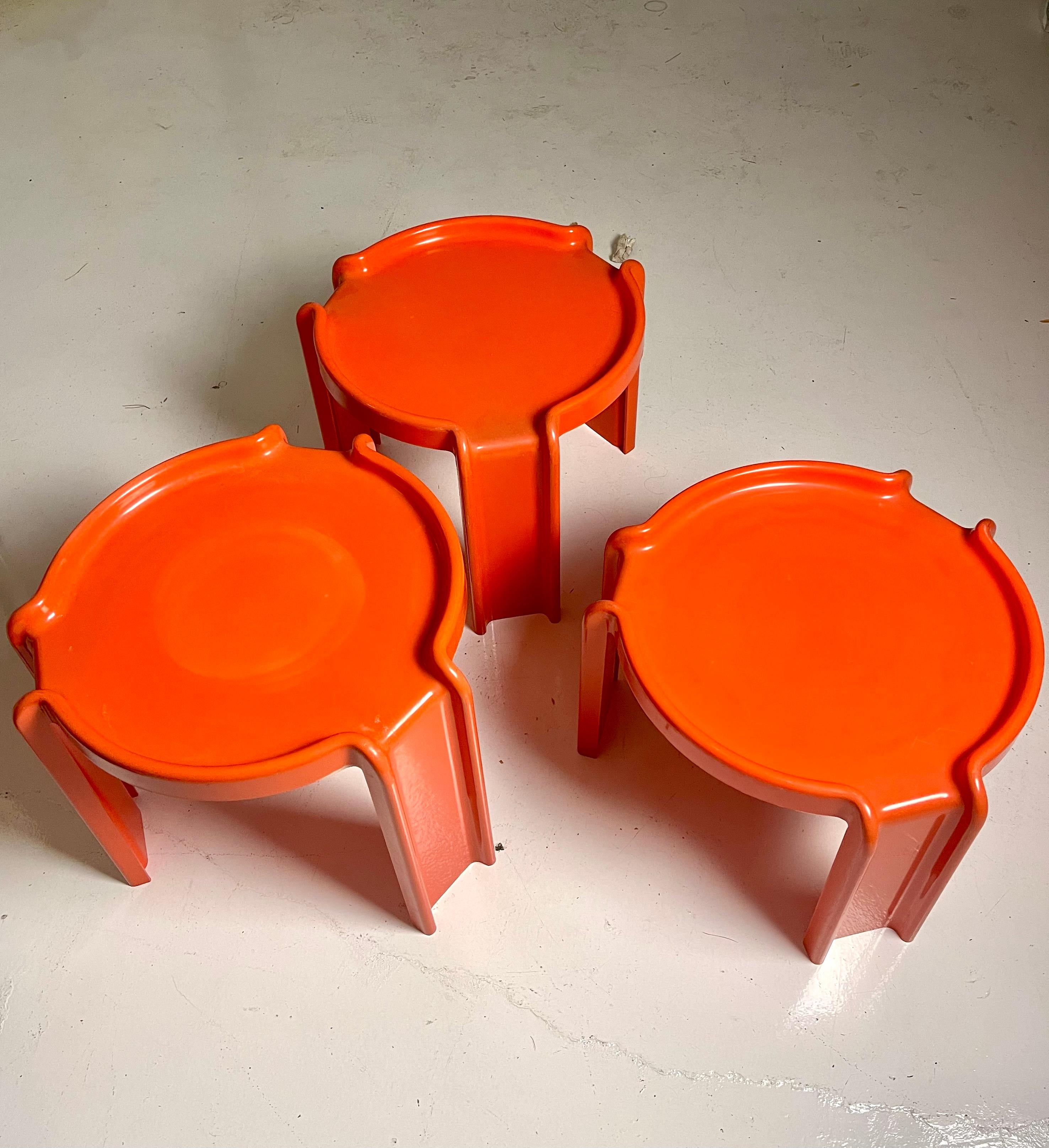 Full set of 3 stacking tables by Giotto Stoppino for Kartell in a rare orange plastic. Surprisingly substantial and in good vintage condition with minor scuffs and fading.