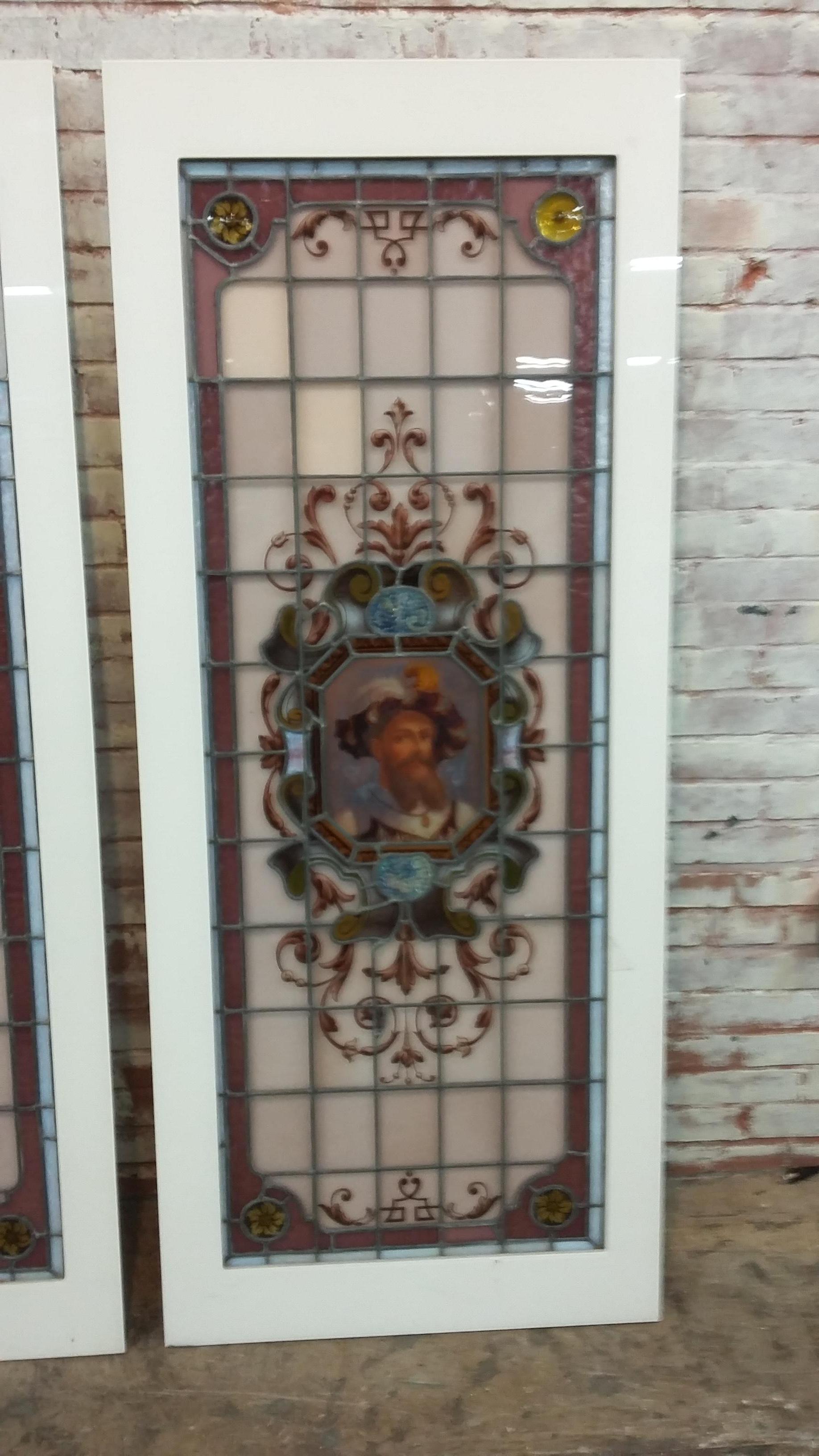 Very unique pair of stained glass panels in newly made plastic frames. The 