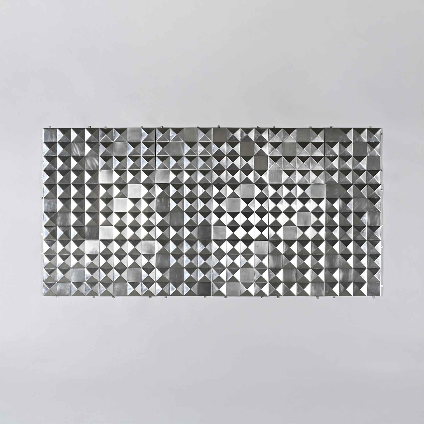 Set of eighteen modular decorative panels featuring raised diamond-point patterns in polished stainless steel. The geometric relief reflects light and creates an optical vibration reminiscent of kinetic art.

Each panel can be mounted individually