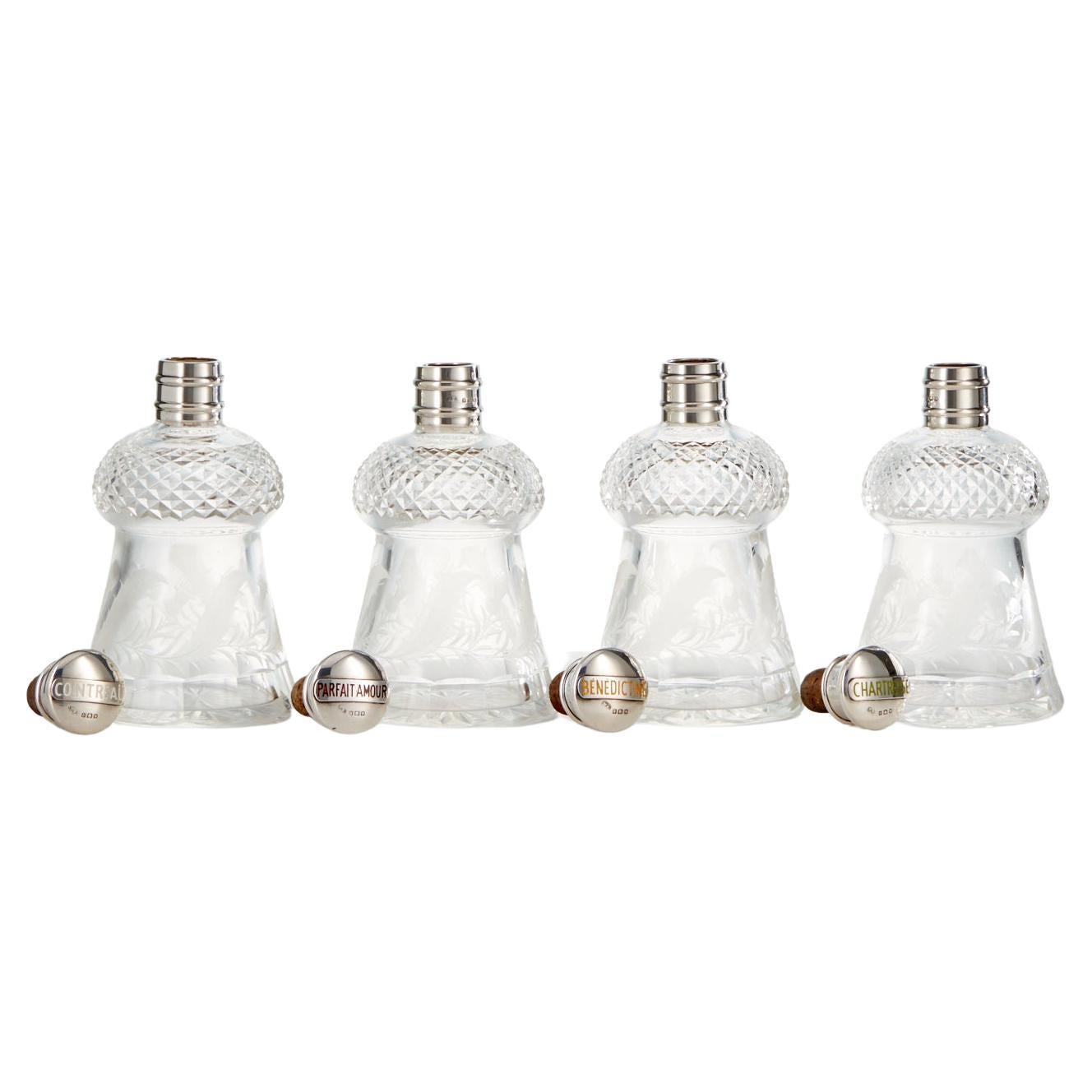 Antique Sterling Silver Decanters with Guilloche Enamel Lids by W G Groves 1933.
A set of 4 sterling silver mounted Liquor Decanters with enamel decoration. Maker Walter Gardener Groves Date 1933

Engraved Hobnail glass with thistle form and