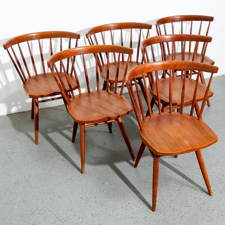 Set of of six Straight back chairs by George Nakashima, Nakashima Studio production. Black walnut frame with hickory spindles. Retains pencil scribe marks on seats.

17
