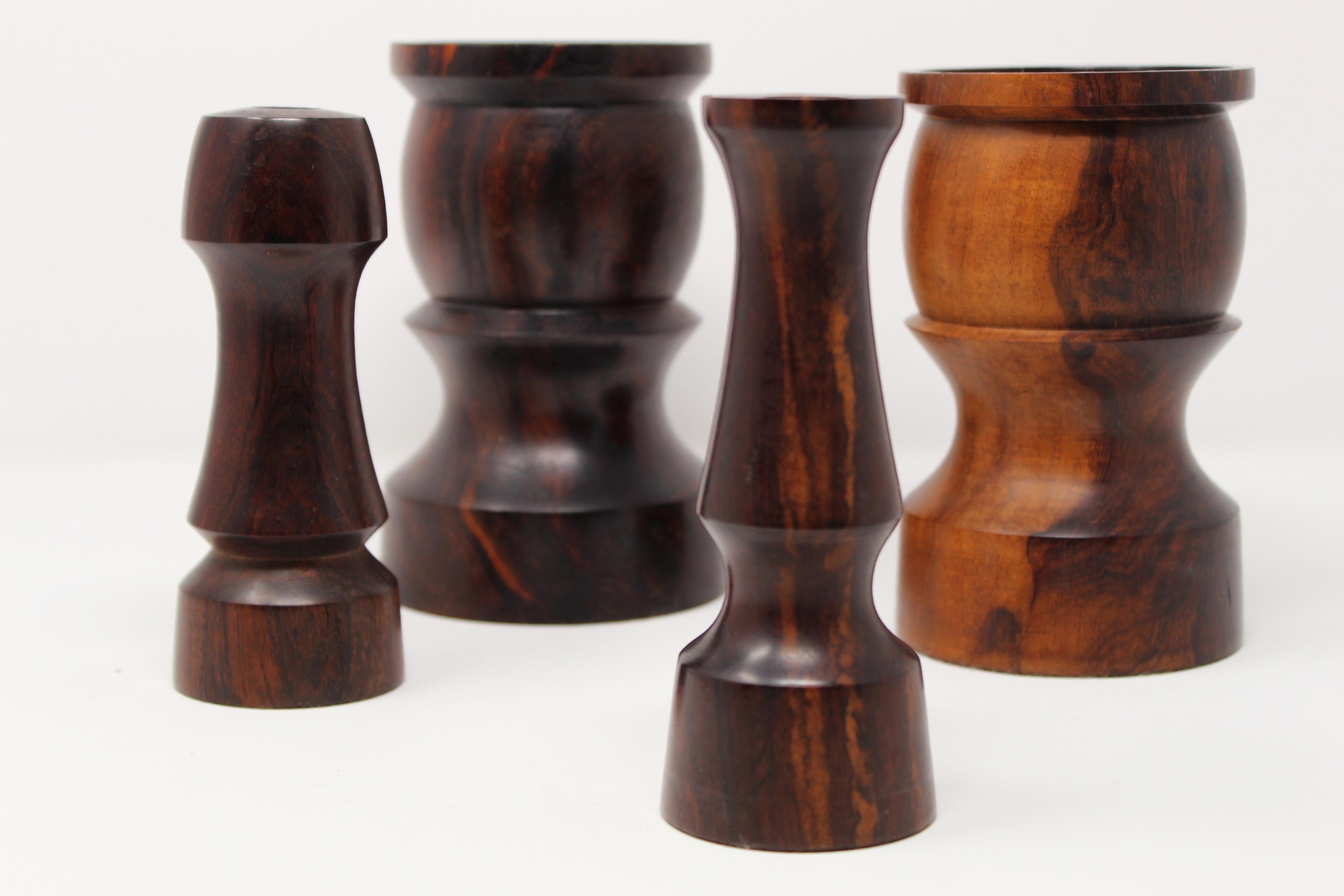 Set or group of 4 finely turned candlesticks by same artist, made of solid rosewood with consistent modernist shapes. We have added several images and different angles with the intent of showcasing beautiful wood grain. Good vintage condition as