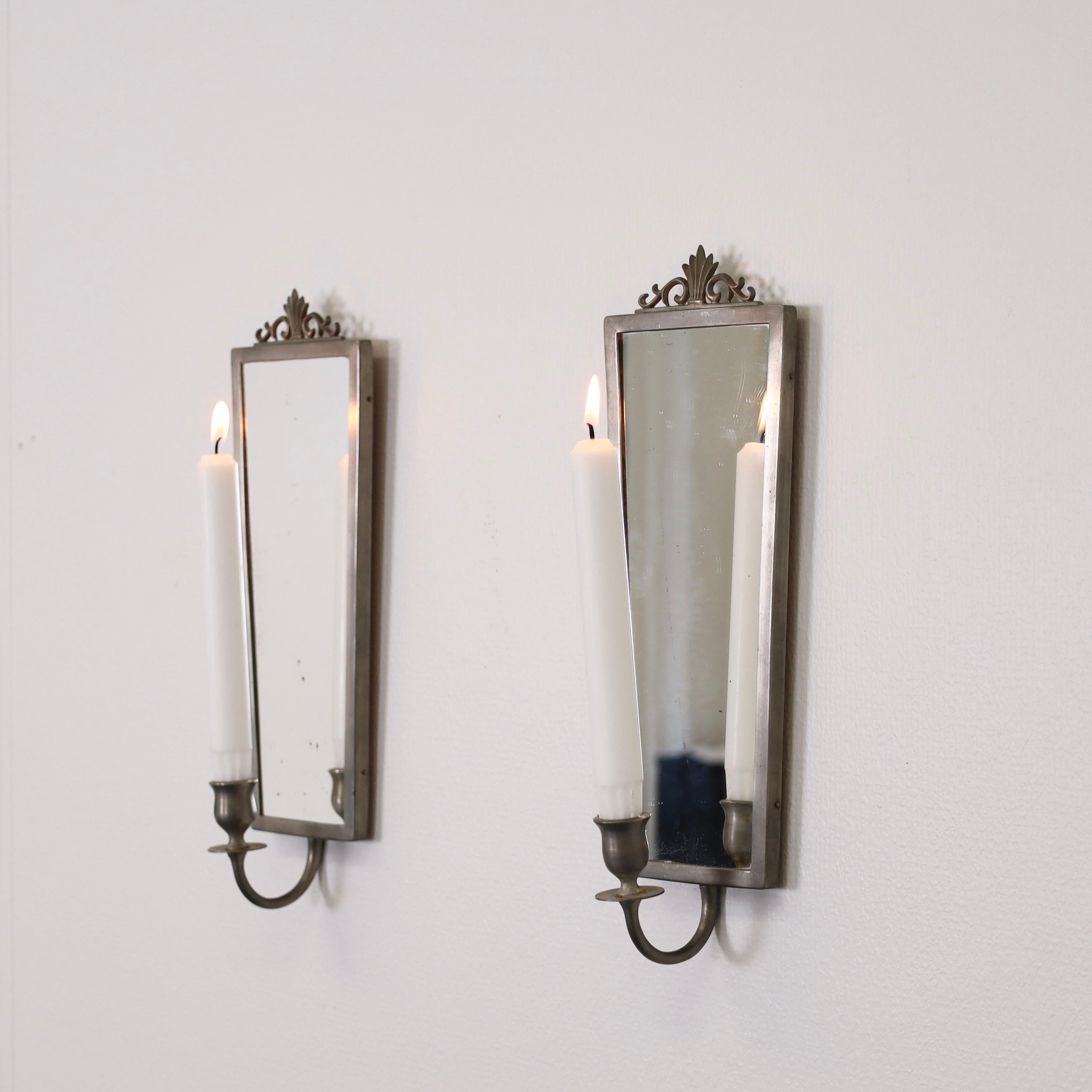 Set of Mirror Wall Candle Sconces made by JL. Hultman, Sweden circa 1930s. A fine duo for a beautiful place. 

* Pewter wall mirror candlestick holders.
* Manufacturer: JL. Hultmann 
* Country: Sweden
* Year: est. 1930s
* Condition: Fair vintage