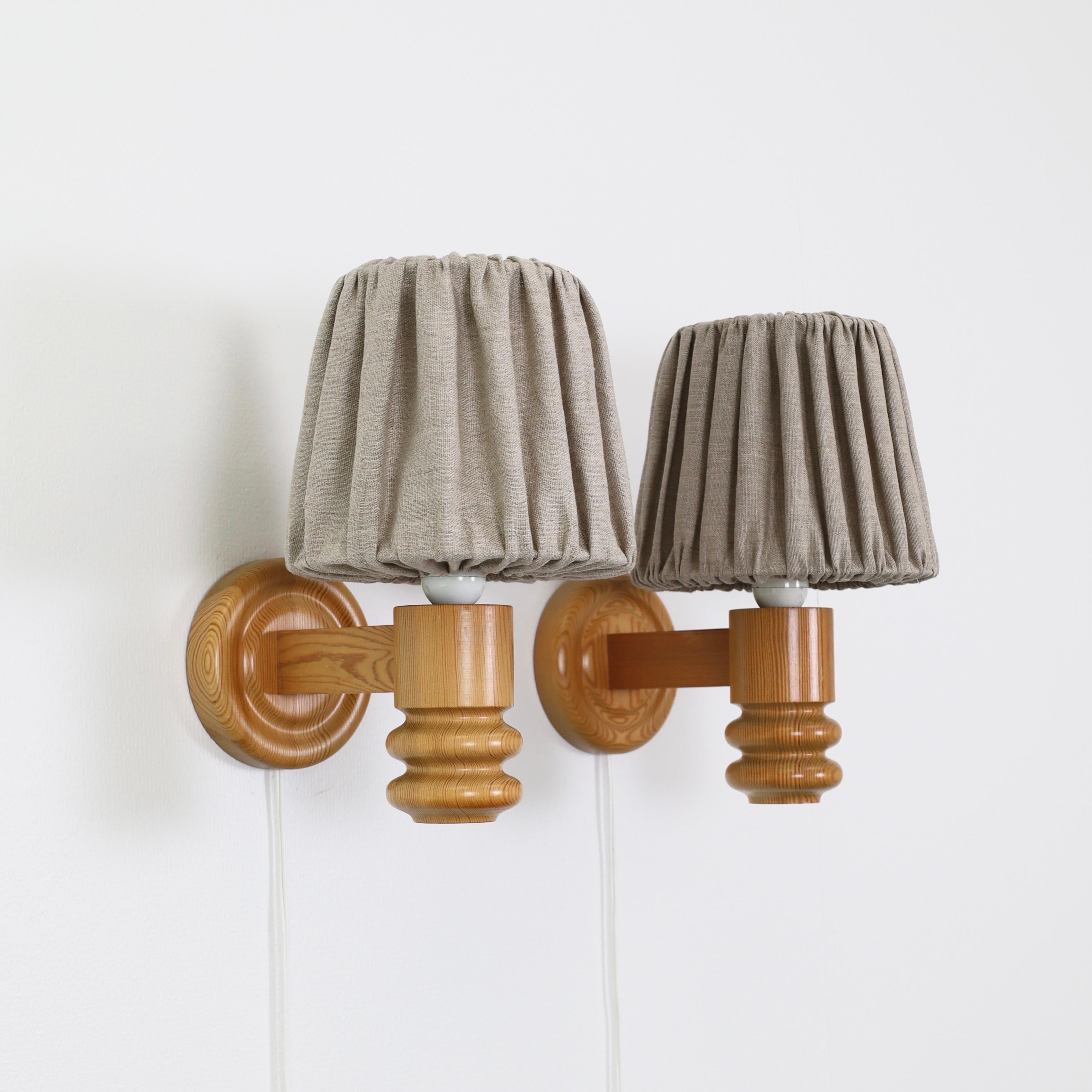 A set Swedish Modern Pine wood Wall lamps made by Solbackens Svarveri in the 1970s. A Scandinavian touch to a beautiful home.

* A pair (2) of Pine wood sconces with beige fabric shades.
* Manufacturer: Solbackens Svarveri, Sweden
* Style: 65
*