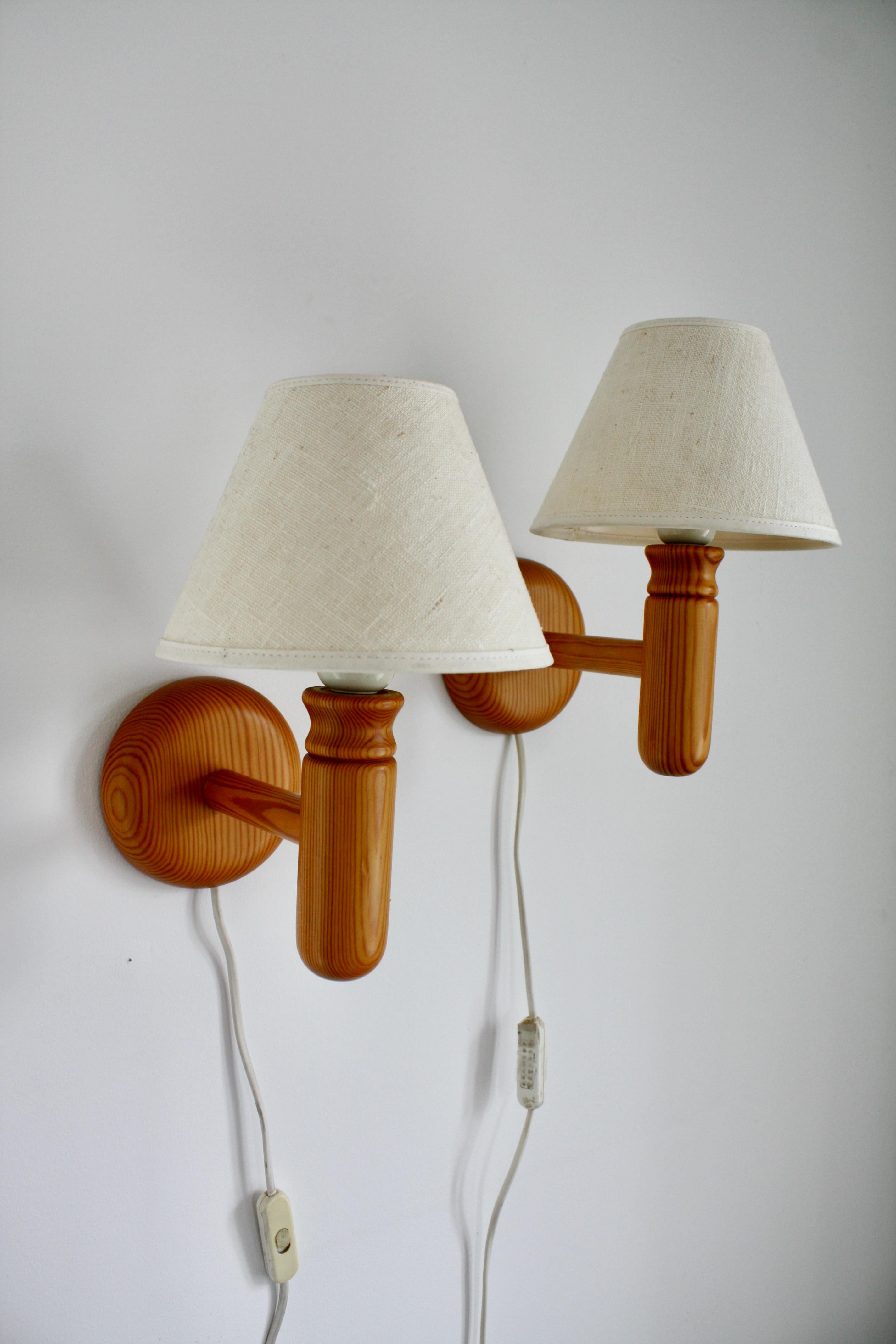 A set of Swedish Modern pine wood wall lamps, by Vigan lightning, in the 1970s. Ivory coloured vintage shades included.
Beautiful as bedside lamps, but also perfect for your hallway or staircase wall.

Currently fitted with a Swedish plug, we
