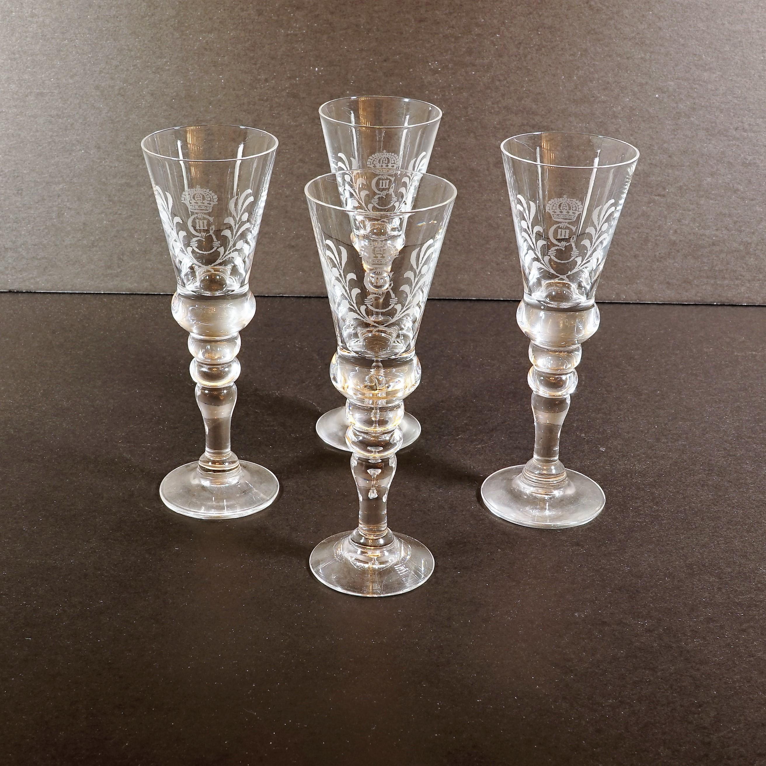 Stylized with the marque of Gustav III, this simple set of snaps glasses evokes the glory of the Swedish Empire for the bourgeoisie of the Swedish Grace period. The glass is designed to keep snaps as cold as possible ahead of toasting.