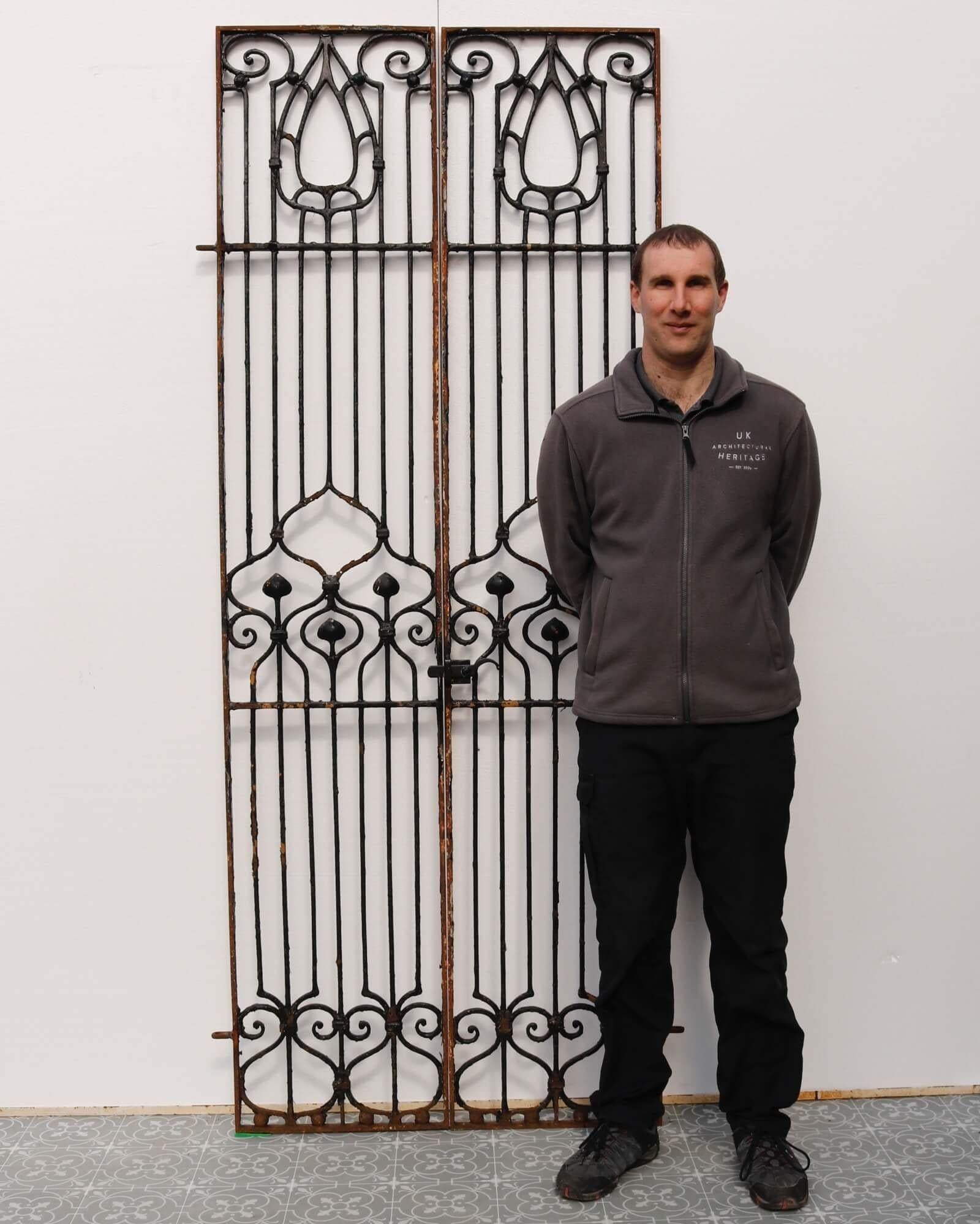 A tall set of late 19th century Art Nouveau style wrought iron gates. These superb gates were originally a pair of panels and have been fitted with modern hinges and latch to create a stunning set of pedestrian gates.
 
Standing at over 2m tall