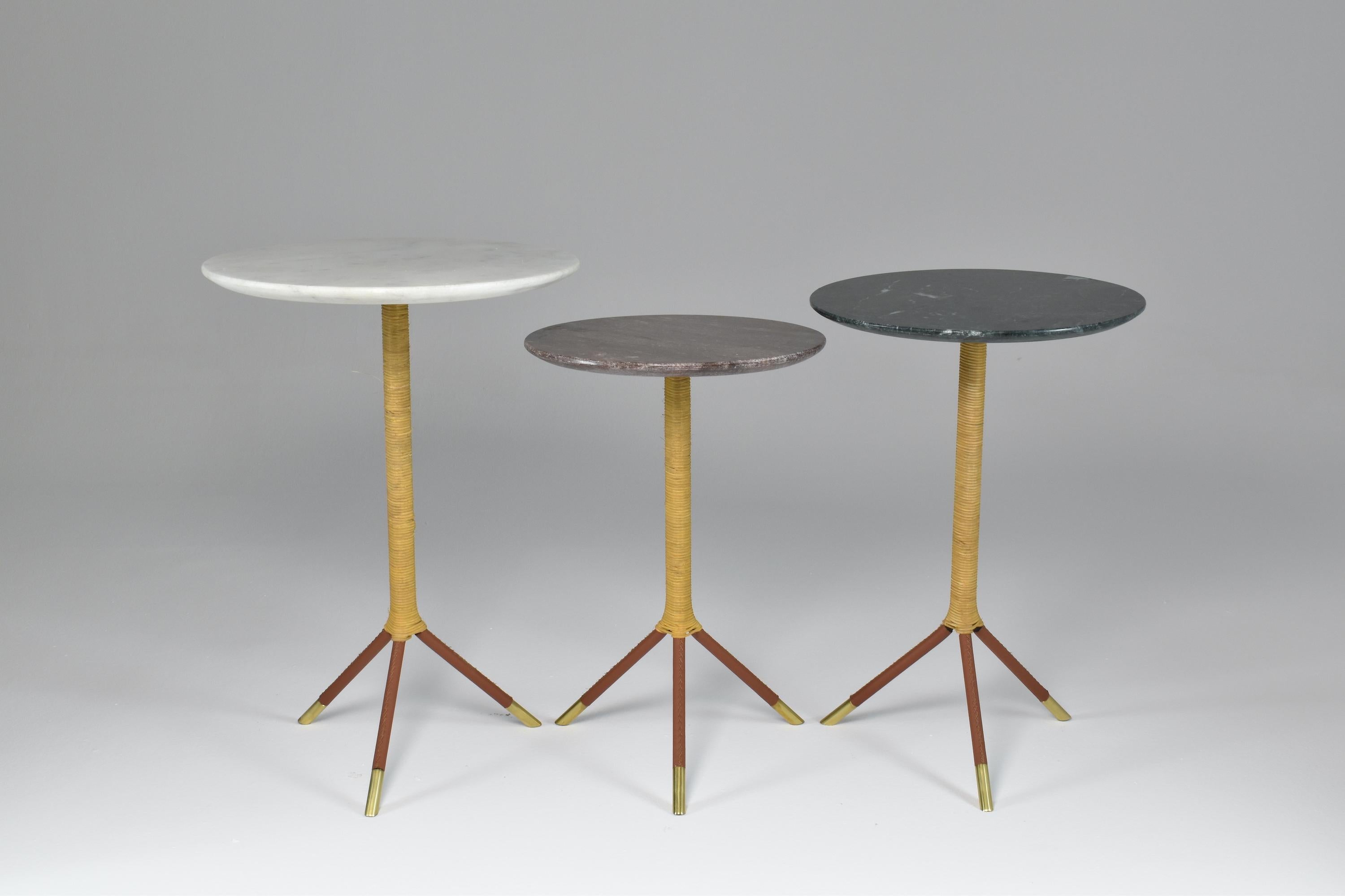 Handcrafted made-to-measure side table designed with a thick polished marble tabletop, a steel structure, and sustainably sourced natural rattan core. The hand-sewn leather sheathed tripod structure is highlighted by chic solid brass endings.