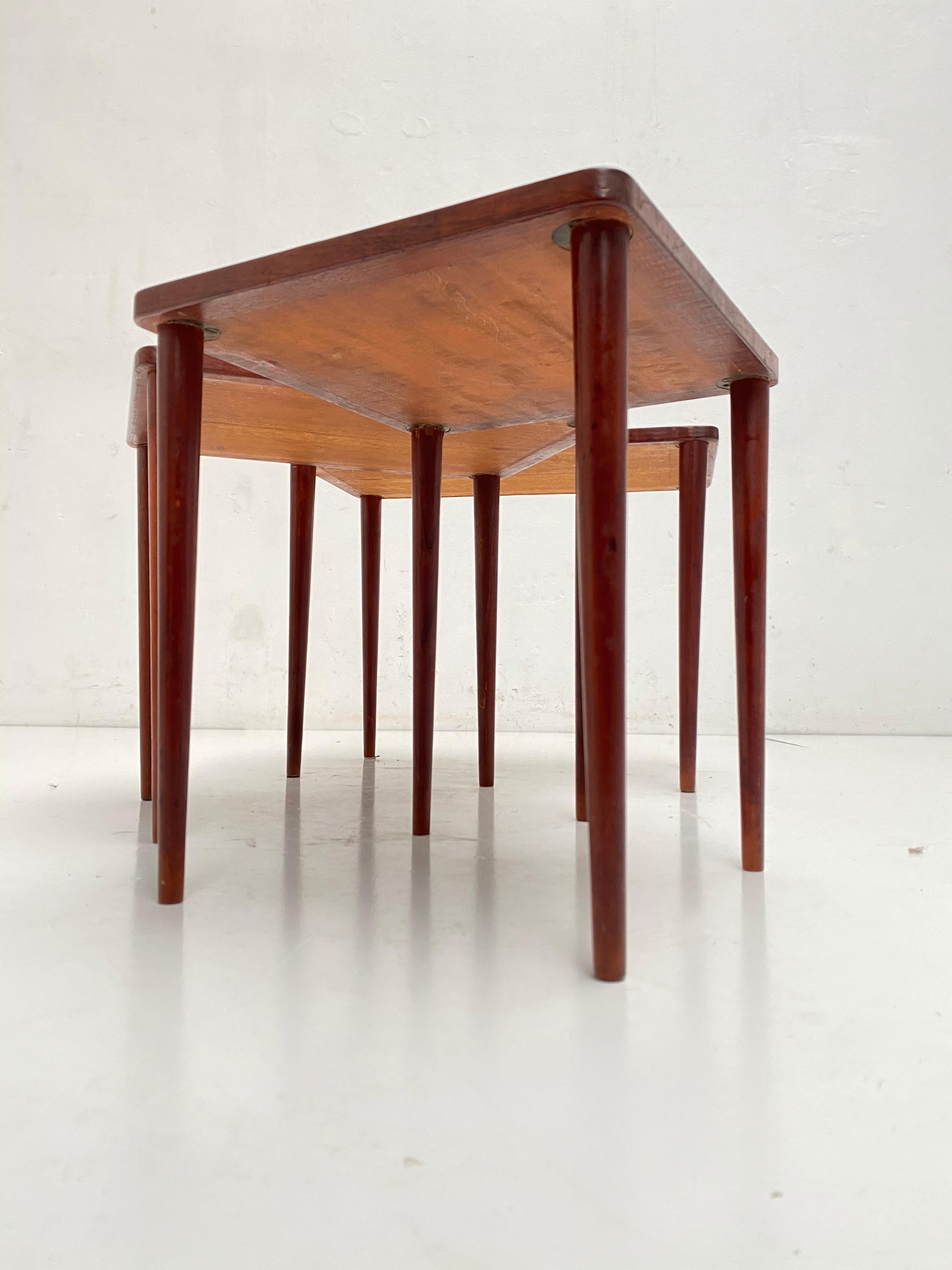 Nice set of 3 Danish production nesting tables from the 1950s in teak wood

The teak wood has a nice aged patina and the legs can be removed for flat pack shipping.